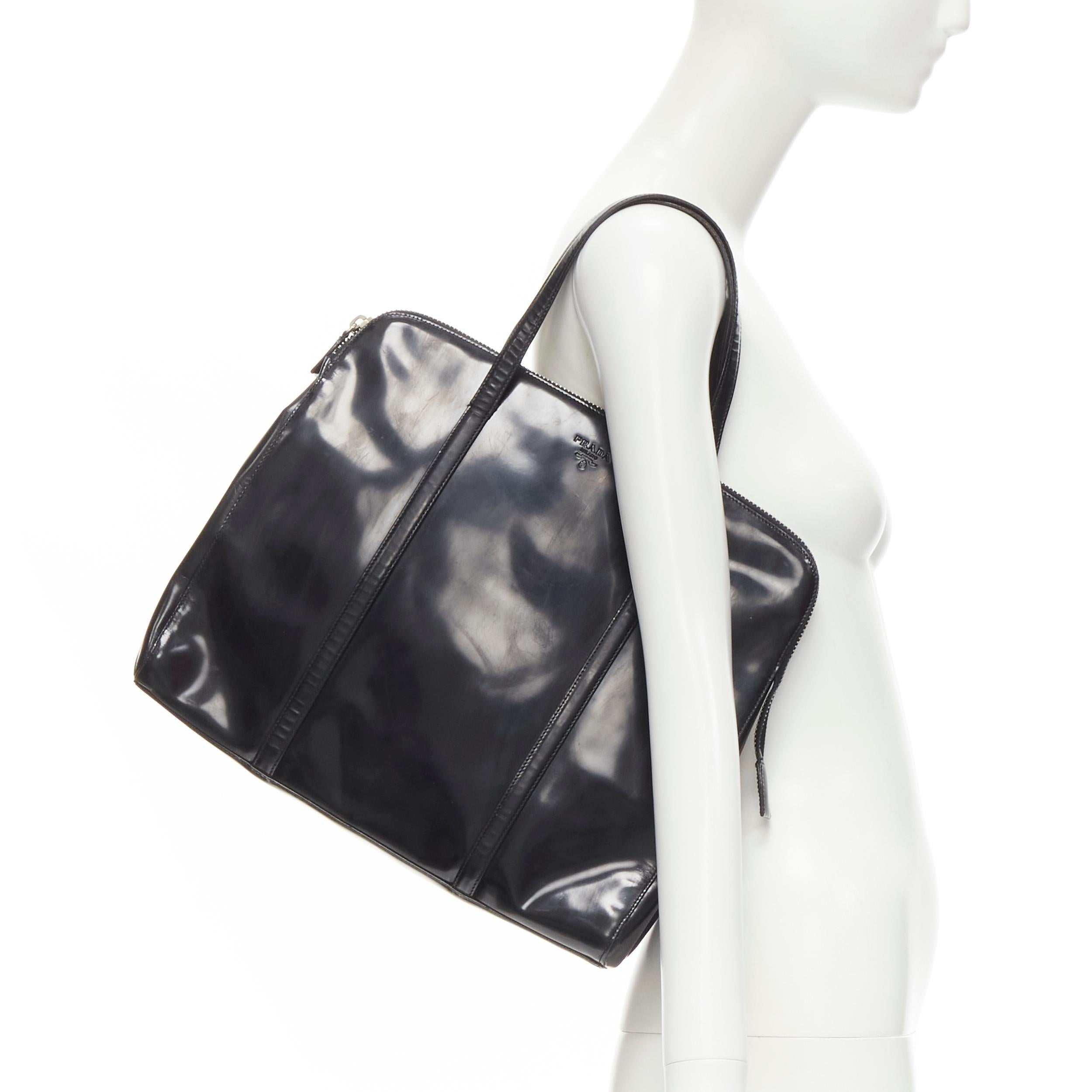 PRADA Vintage black shiny leather top handle large top bag 
Reference: AEMA/A00068 
Brand: Prada 
Material: Leather 
Color: Black 
Pattern: Solid 
Closure: Zip 
Extra Detail: Logo embossed at front. Top zip closure. 
Made in: Italy 

CONDITION: