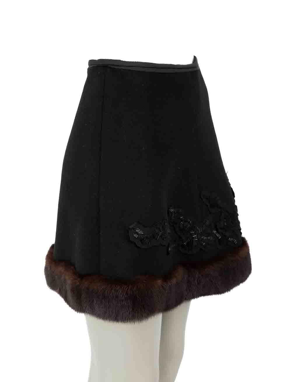 CONDITION is Very good. Minimal wear to skirt is evident. Minimal wear to the embellishment with missing beads on this used Prada designer resale item.
 
Details
Vintage 
Black
Wool
A-line skirt
Mini
Mink fur trim
Bead embellished detail
Back zip