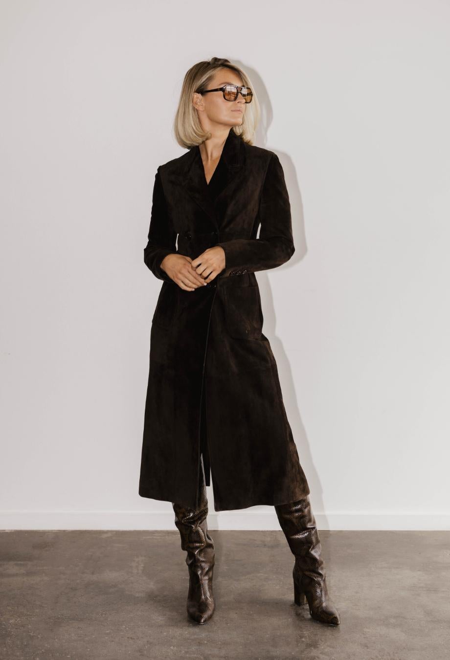 Prada’s vintage brown suede coat is a masterclass in understated luxury synonymous with the brand’s early designs. Cut for a soft luxurious silhouette, the double-breasted shape is softened by its sumptuously smooth suede, which drapes elegantly