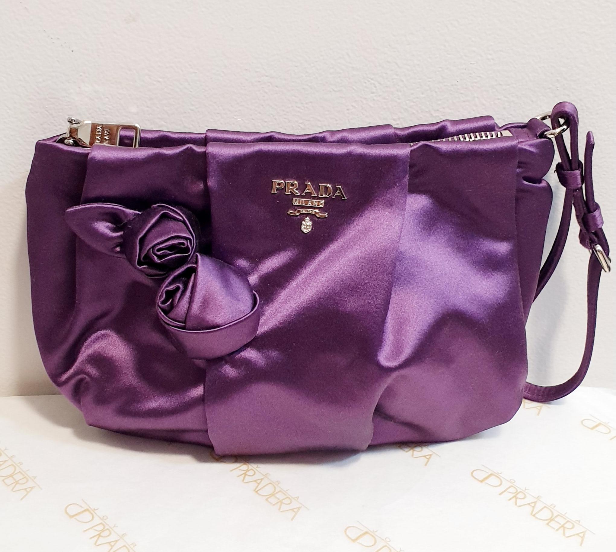 New Prada Violet flower silk  handBag with certificate
Prada silk handbag with wrist strap. Interior lined in light silk.
 With certificate and dustbag 
Silver hardware. 
Rest of boutique stock
Never used
Original bag and papers
Dimensions:
Length: