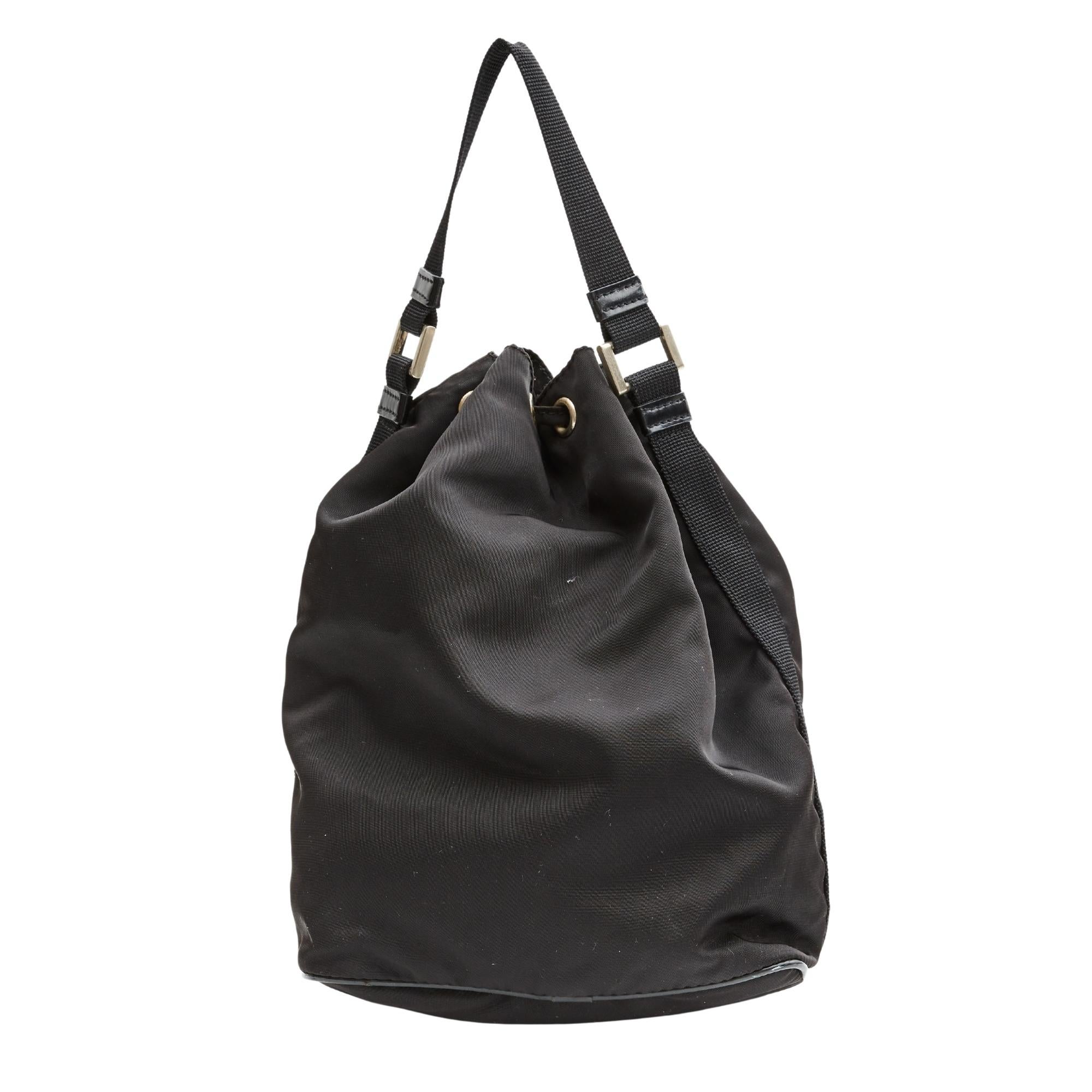 COLOR: Black
MATERIAL: Nylong
ITEM CODE: No code due to vintage state.
MEASURES: H 9” x L 6.5” x D 4”
DROP: 5”
CONDITION: Good - bag shows signs of use with light scuffs to nylon and leather pipping. Discolouration.

Made in Italy