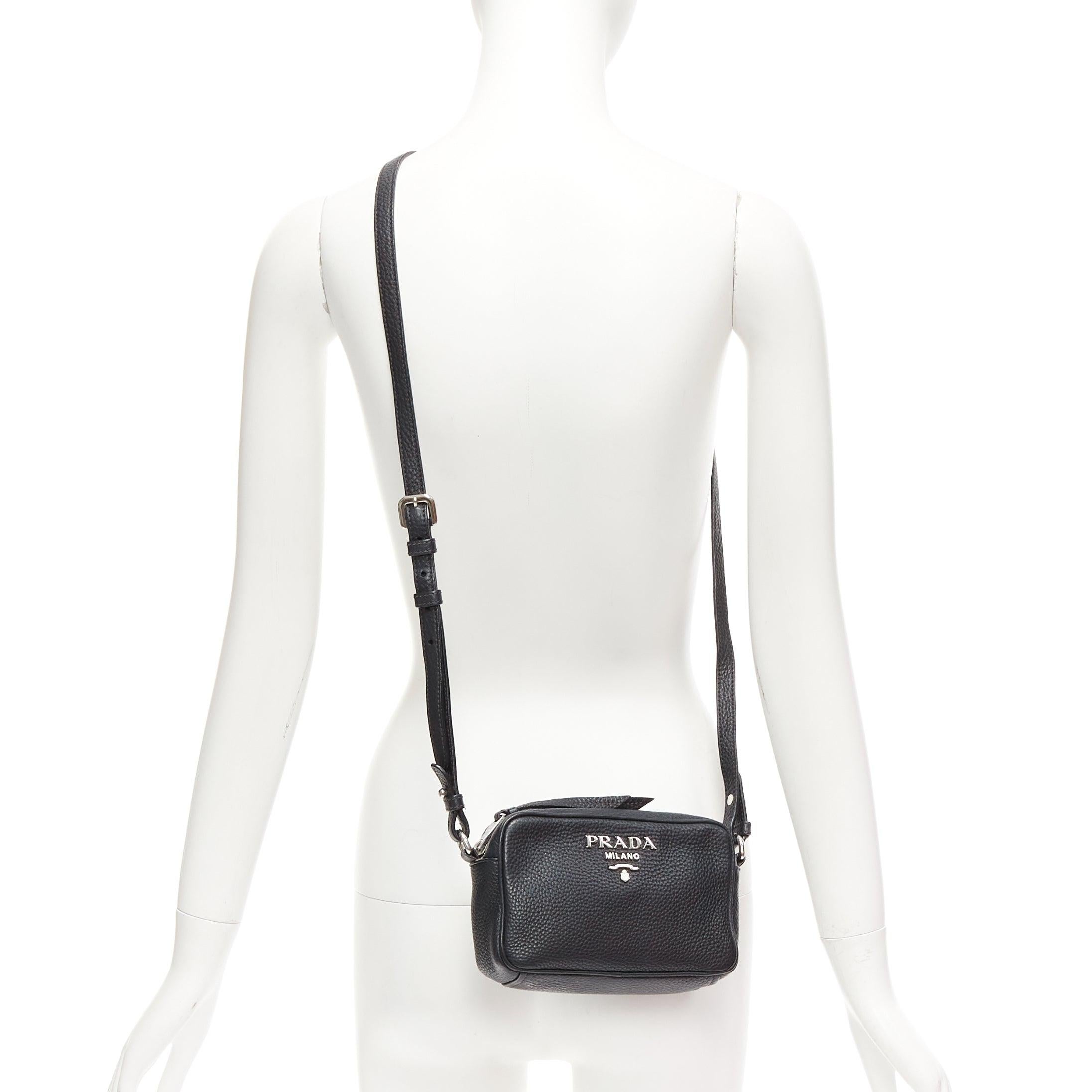 PRADA Vitello Daino black calfskin silver logo zip crossbody camera bag
Reference: TGAS/D01155
Brand: Prada
Designer: Miuccia Prada
Model: 1BH096
Collection: Vitello Daino
Material: Leather
Color: Black, Silver
Pattern: Solid
Closure: Zip
Lining: