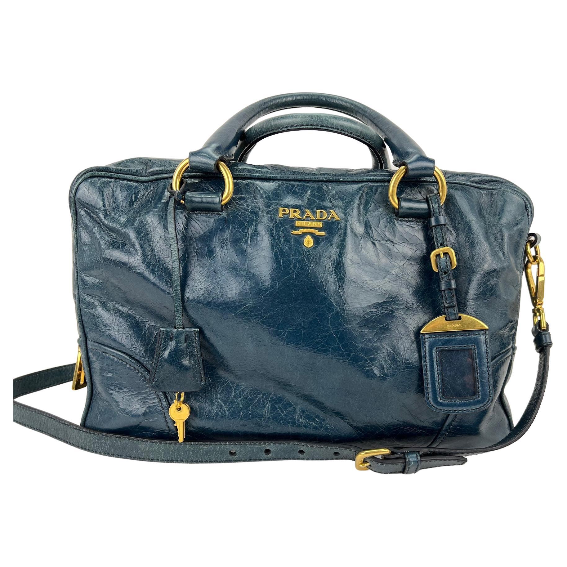 Pre-Owned  100% Authentic
PRADA Vitello Shine Shopping Satchel Denim 
W/Added Insert to help keep shape and organize
RATING: B...Very Good, well maintained, 
shows minor signs of wear
MATERIAL: distressed shiny leather 
STRAP: Prada Leather