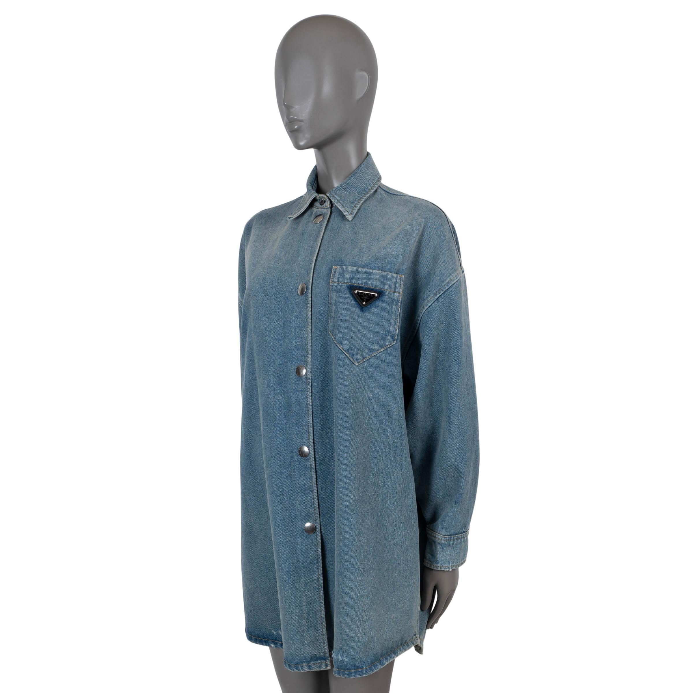 100% authentic Prada oversized denim shirt dress washed blue cotton (100%). Features contrasting yellow stitching, chest patch pocket with triangle logo patch and buttoned cuffs. Can also be worn as a mini dress. Closes with silver-tone snap buttons