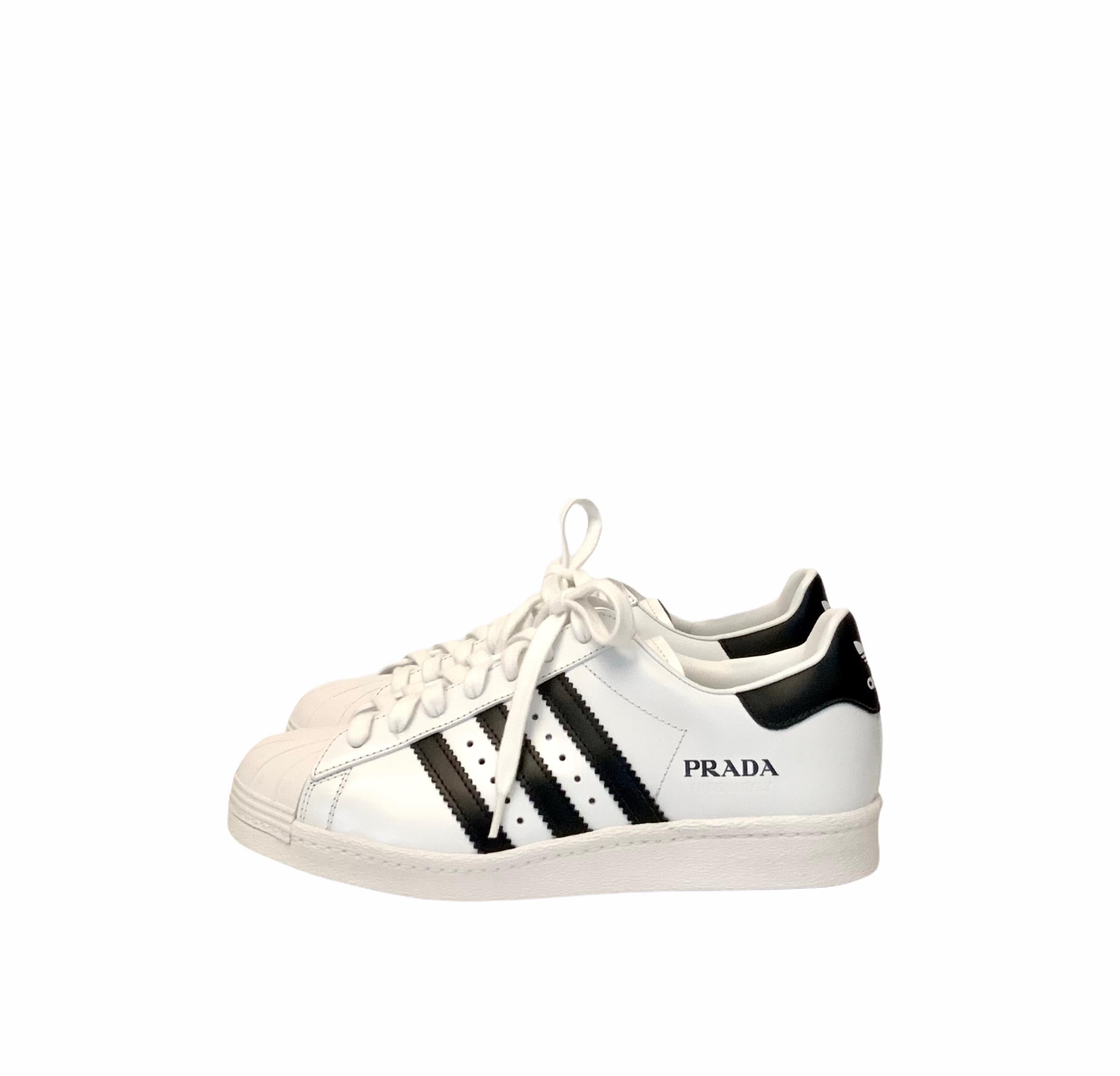 Born from the collaboration between Prada and Adidas, these pre-owned but new Superstar sneakers are handmade in Italy.
Crafted with a fine full grain leather, these Superstars feature the iconic rubber “shelltoe” with the iconic black typography