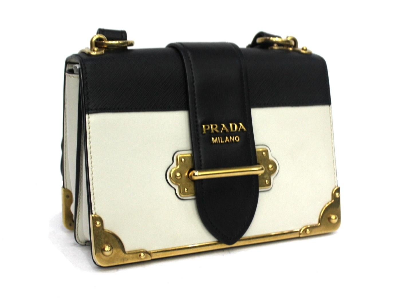 Prada model bag made of black and white leather with golden details.

Excellent condition.