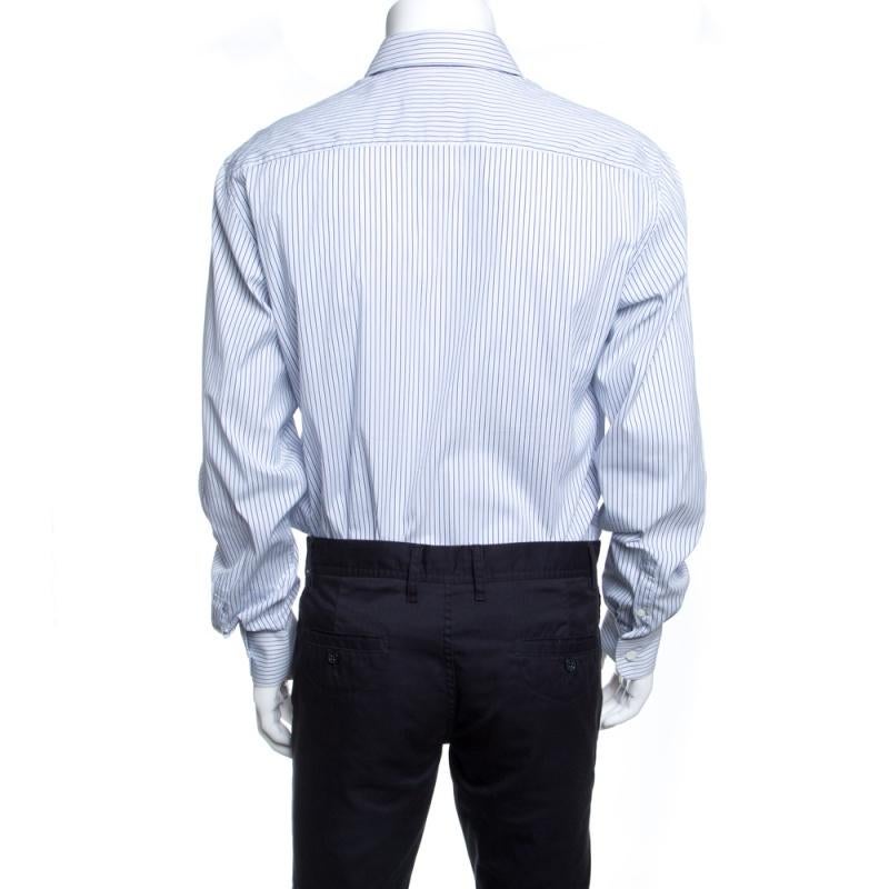 Express your unique style with this shirt from Prada. It is crafted from a cotton-nylon blend and features a white and blue striped pattern all over. Complete with long sleeves and button front closure, this shirt will complement your formal look on