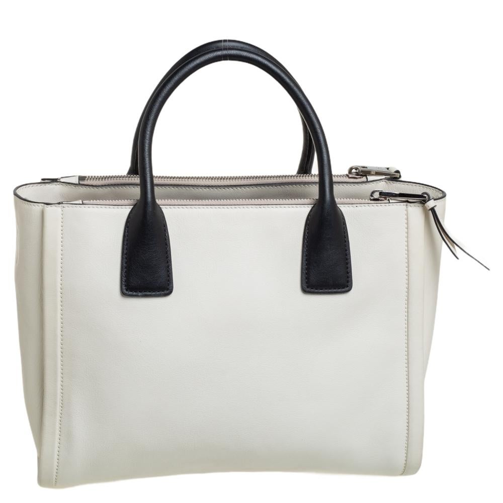 Feminine in shape and grand in design, this Concept tote by Prada will be a loved addition to your closet. It has been crafted from leather and styled minimally with silver-tone hardware. It comes with two top handles and a perfectly sized main