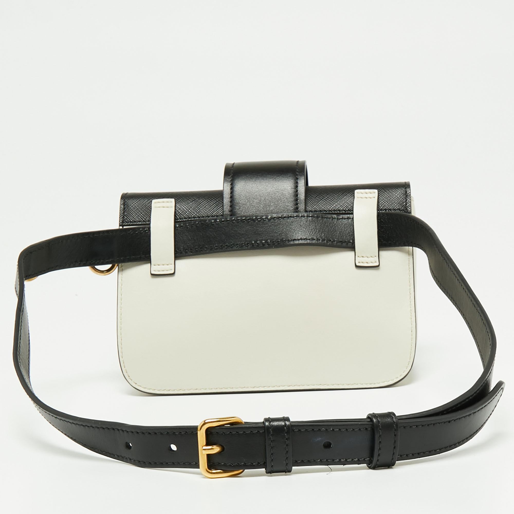 Inspired by valuable books from ancient times, the Cahier by Prada is a best-seller. This belt bag is crafted in Italy using white/black leather. The strap-detailed flap with the brand logo opens to a lined interior and the belt strap allows the