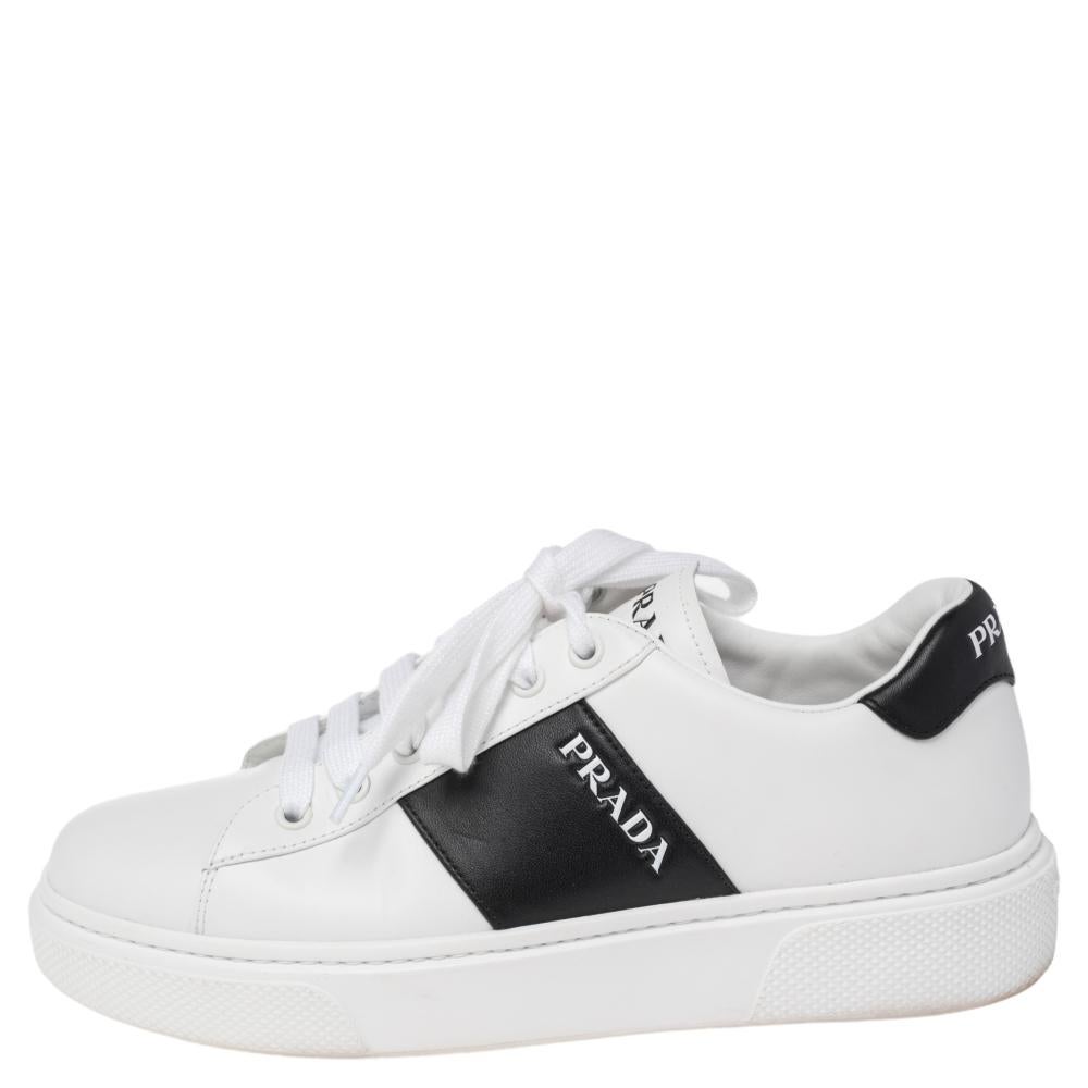 Built to last and add sophistication to any outfit, these leather sneakers by Prada are all you need. The simple look makes these white sneakers look extremely stylish. They feature lace-up uppers, black panels on the sides and counters, and rubber