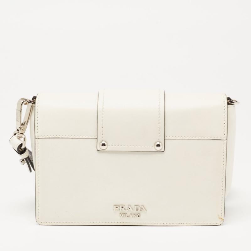 Experience the beauty of fine craftsmanship with this immaculately designed leather bag by Prada. It has a shoulder strap, strap-detailed flap, and a fabric-lined interior.

Includes: Original Dustbag, Detachable Strap