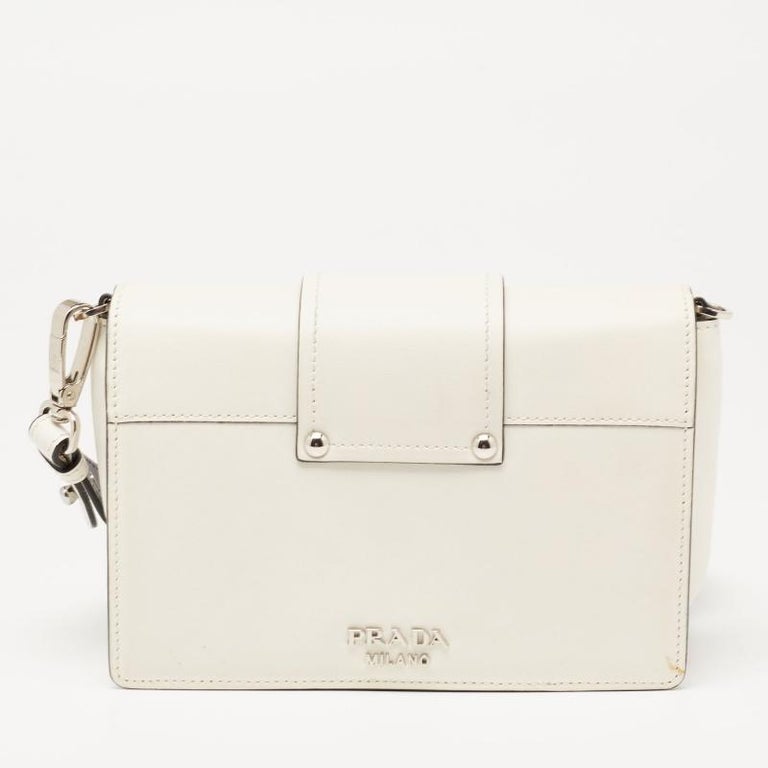Experience the beauty of fine craftsmanship with this immaculately designed leather bag by Prada. It has a shoulder strap, strap-detailed flap, and a fabric-lined interior.

Includes: Original Dustbag, Detachable Strap
