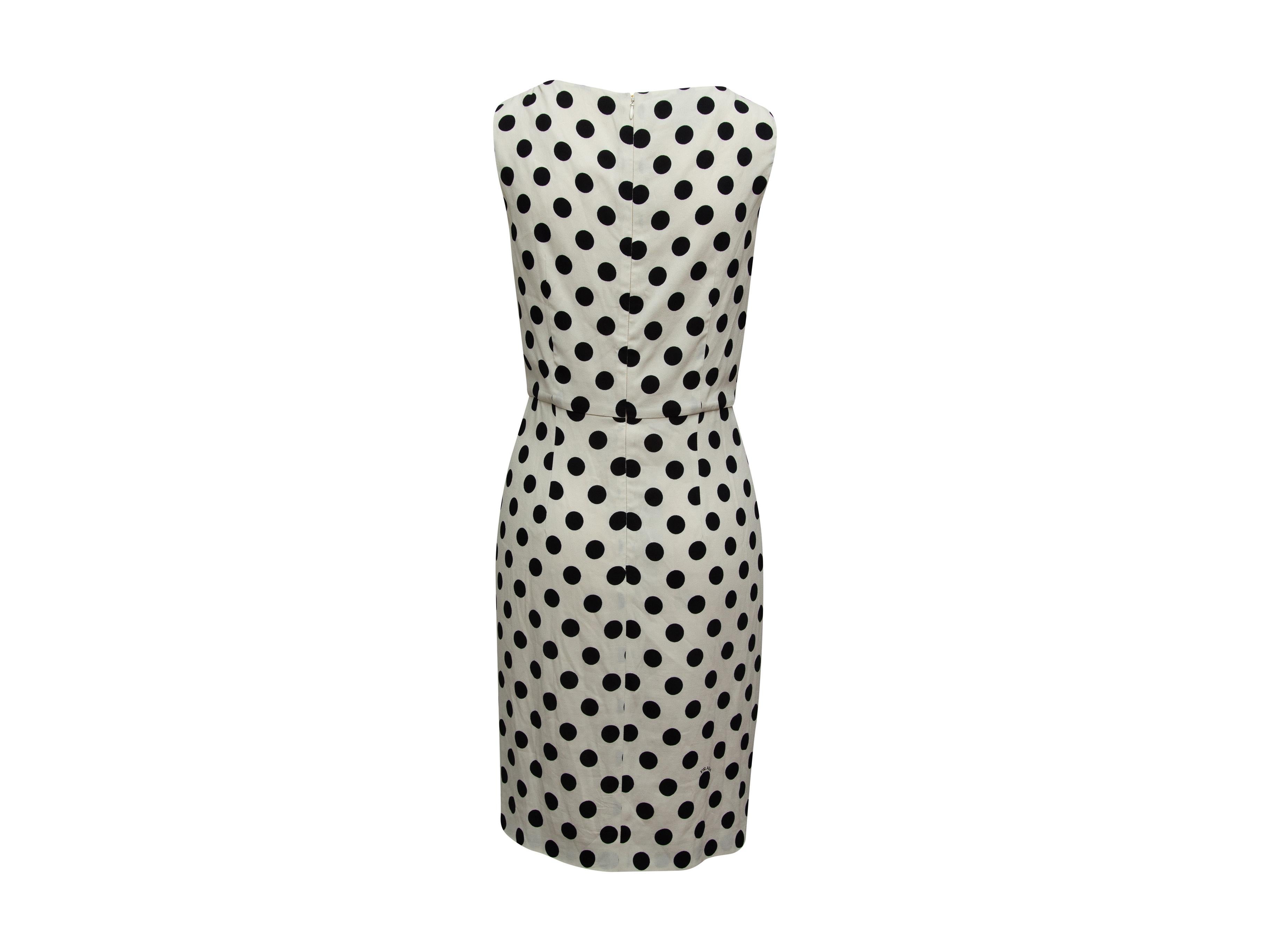 Product details: White and black sleeveless dress by Prada. Polka dot print throughout. Boat neck. Gathering at hips. Zip closure at center back. Designer size 42. 36