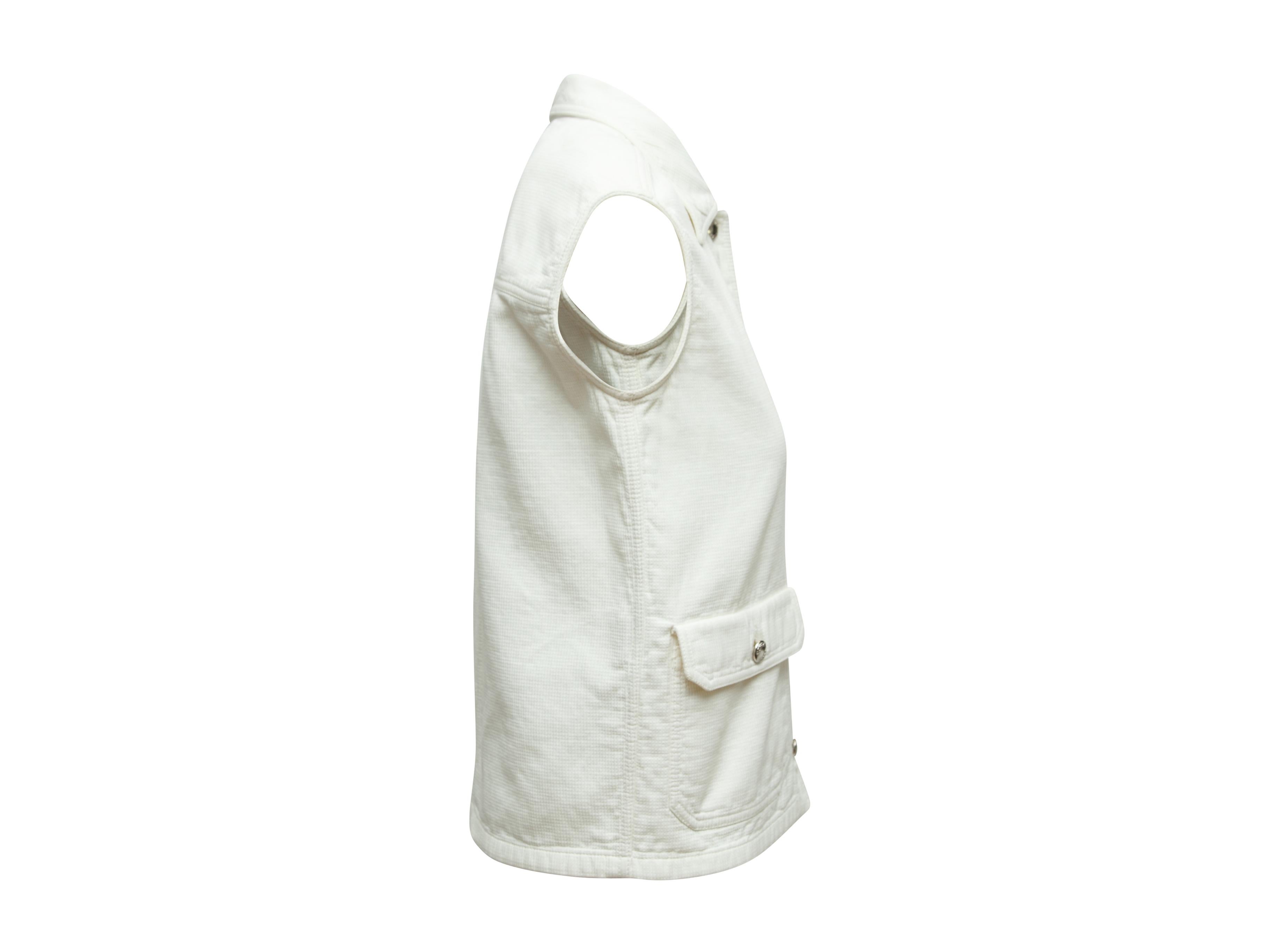 Product details: Vintage white vest by Prada. Pointed collar. Dual pockets. Button closures at center front. 36