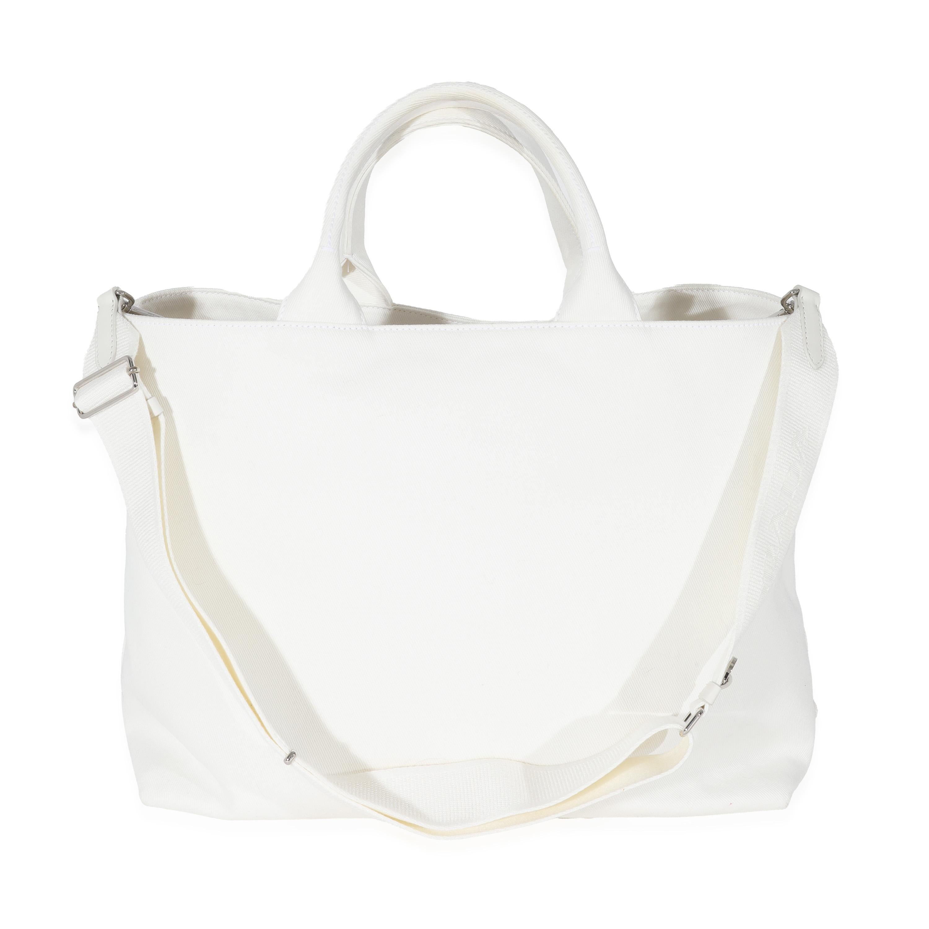 Listing Title: Prada White Canvas Medium Embossed Drill Tote
SKU: 129970
MSRP: 2350.00 USD
Condition: Pre-owned 
Handbag Condition: Very Good
Condition Comments: Item is in very good condition with minor signs of wear. Discoloration