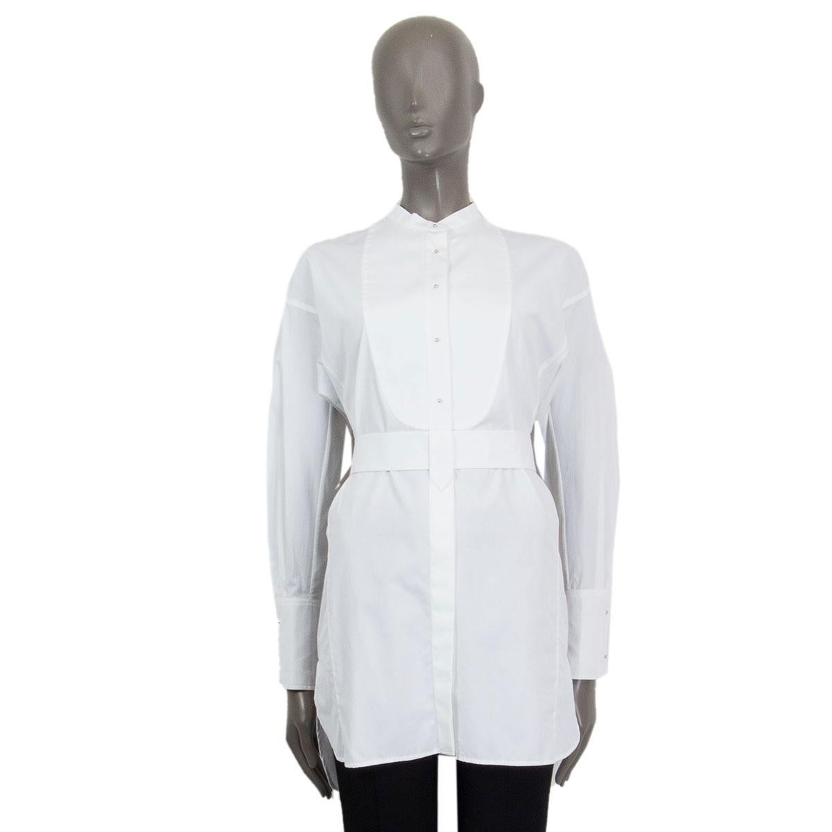 100% authentic Prada belted oversized shirt in white cotton (100%). Features half concealed buttons and round silver-tone metal buttons at top part. Stand-up collar, striking cuffs and a slightly longer back. Brand new. 

Tag Size 38
Size