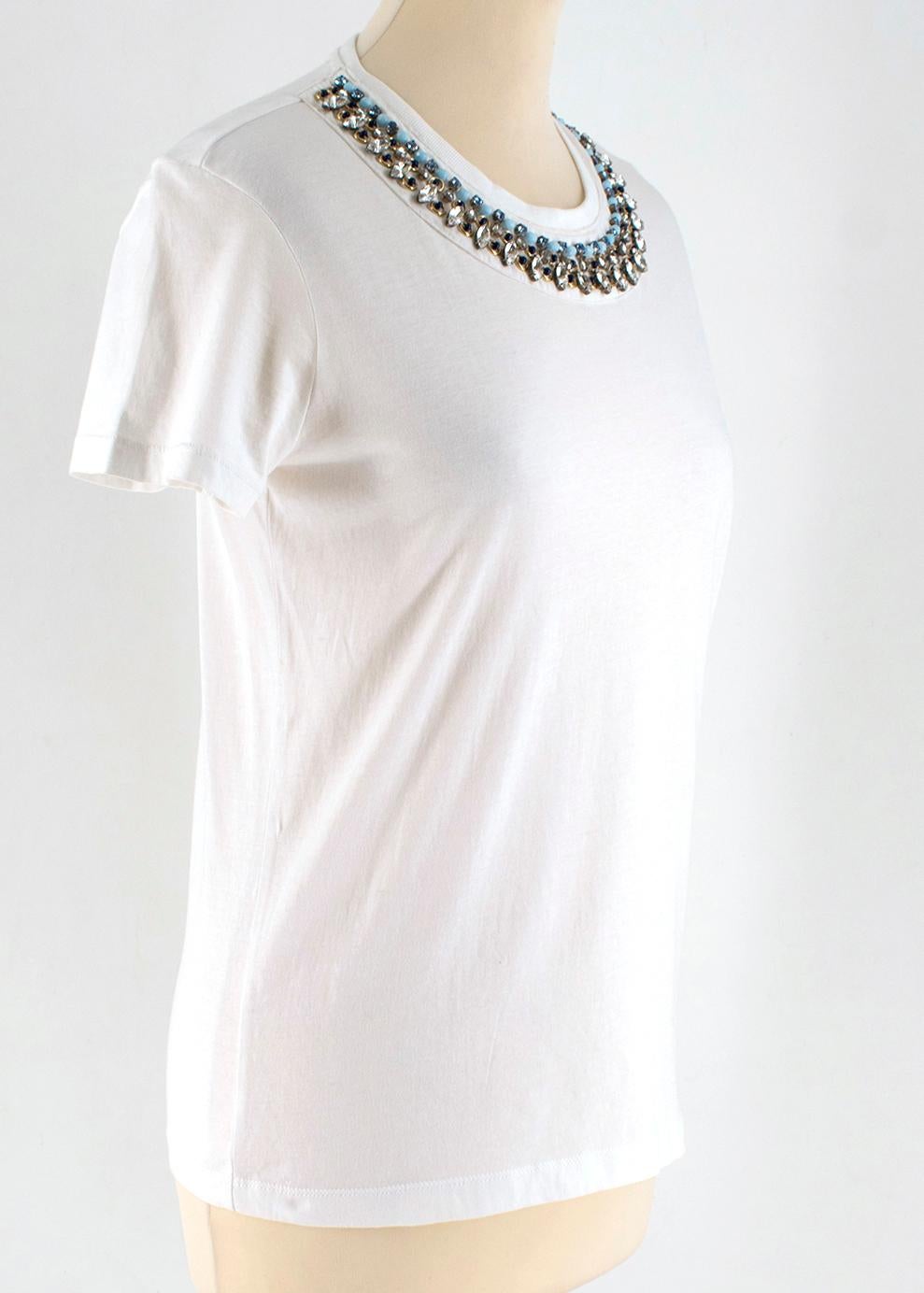 Prada White Cotton Embellished T-shirt

- white cotton t shirt 
- crystal and bead embellished to the collar
- round neckline 

This seller usually wears XS-  S size

Approx:
Measurements are taken with the item lying flat, seam to seam.
Shoulders: