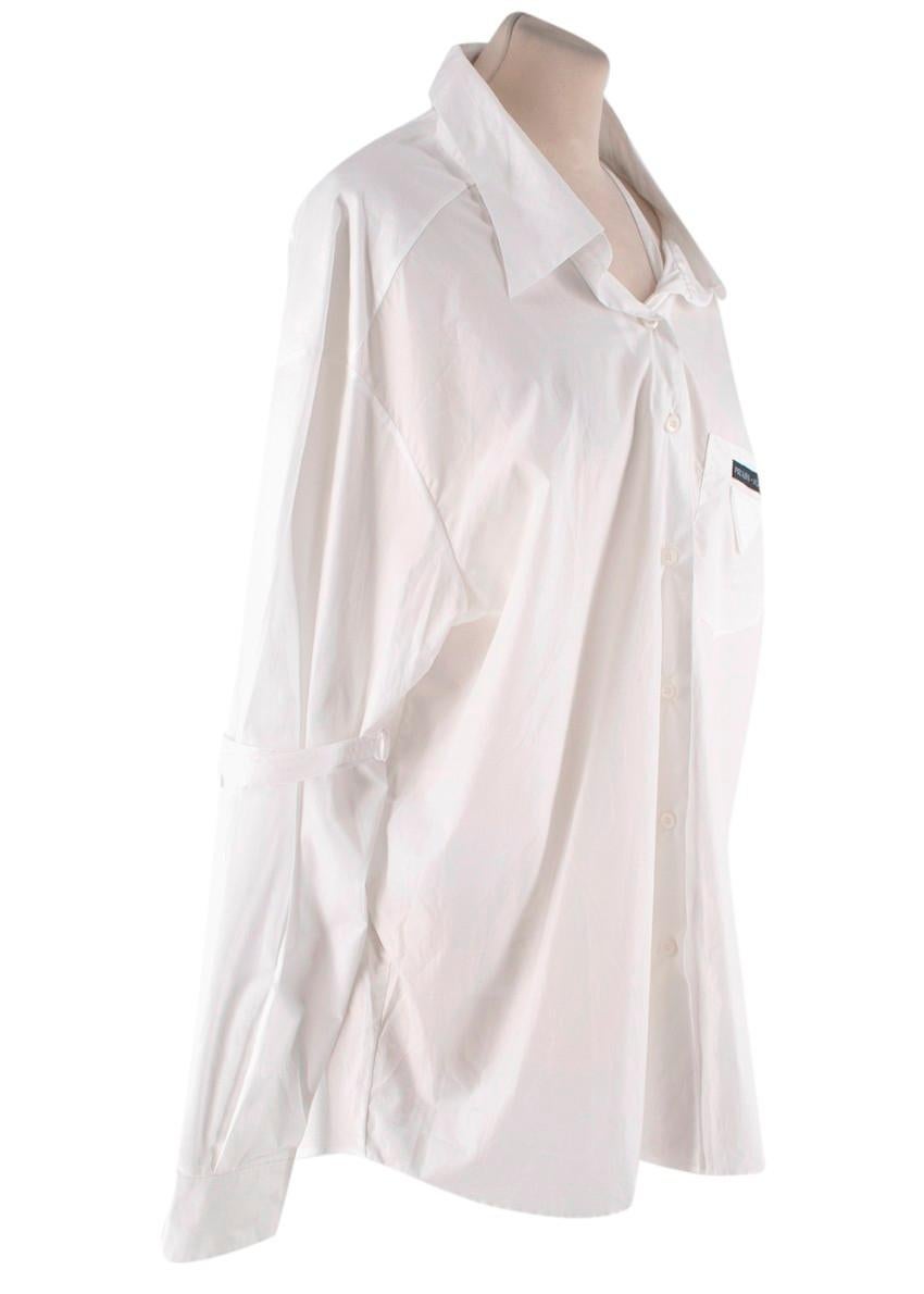 Prada White Cotton-Poplin Logo Applique Shirt
 

 - Boxy cotton poplin shirt, with directional back 'V' seam detail, and exaggerated long sleeves with strap detail at the elbow
 - Patch breast pocket featuring Prada logo and signature triangular