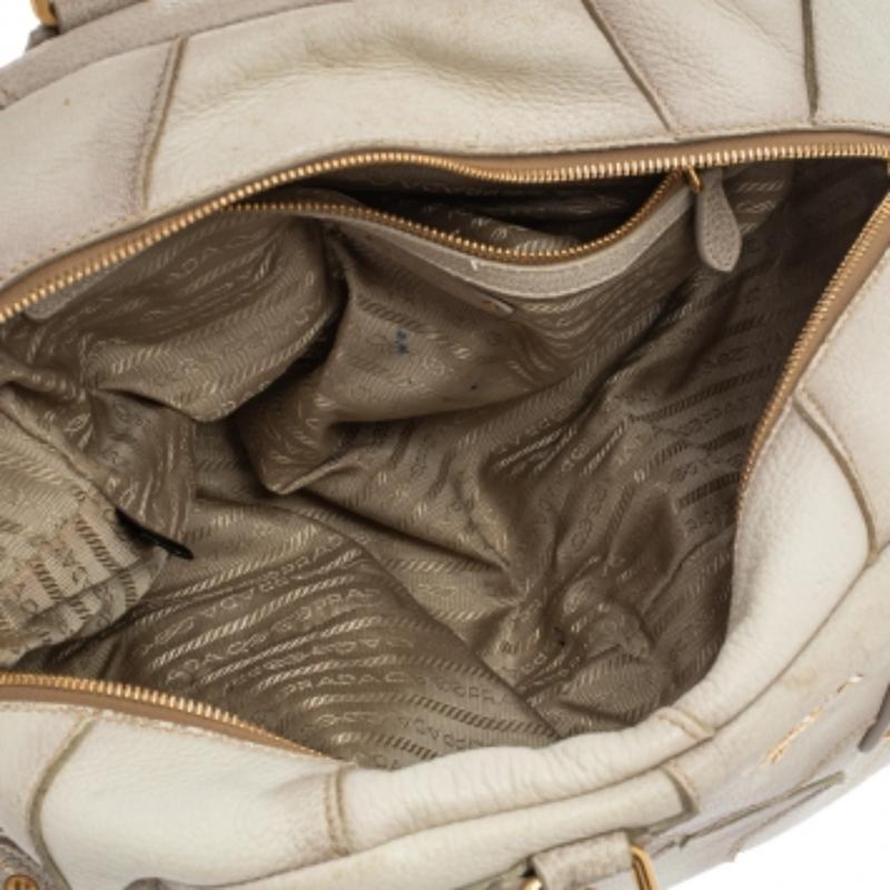Luxury and elegance are personified with this brilliantly crafted Bowler bag from Prada. The bag is made in a patchwork design using deerskin, crocodile leather, and lizard trims. It has two handles and the zip-top closure opens to a nylon-lined