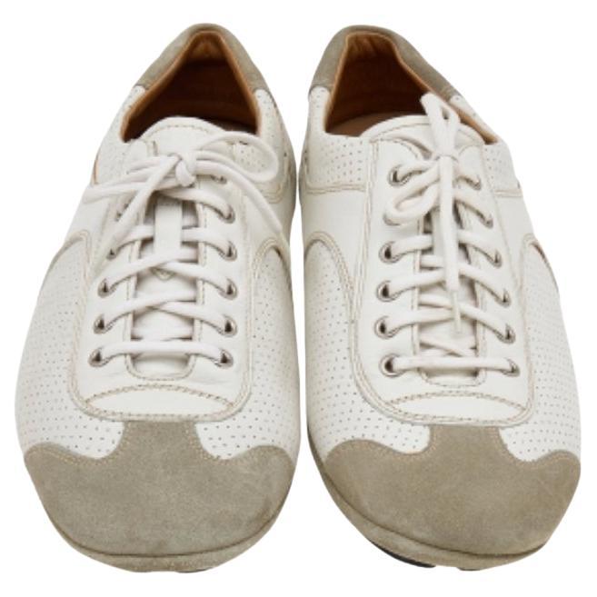 The House of Prada brings you these super stylish sneakers to elevate your appearance! They are crafted using white-grey leather and suede into a low-top silhouette. They exhibit lace-up fastenings and perforated details on the vamps. Walk with