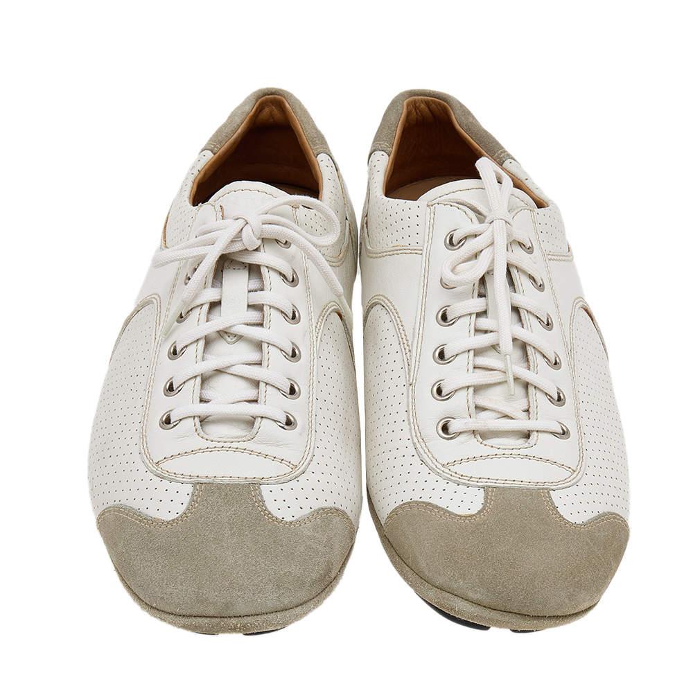 The House of Prada brings you these super stylish sneakers to elevate your appearance! They are crafted using white-grey leather and suede into a low-top silhouette. They exhibit lace-up fastenings and perforated details on the vamps. Walk with
