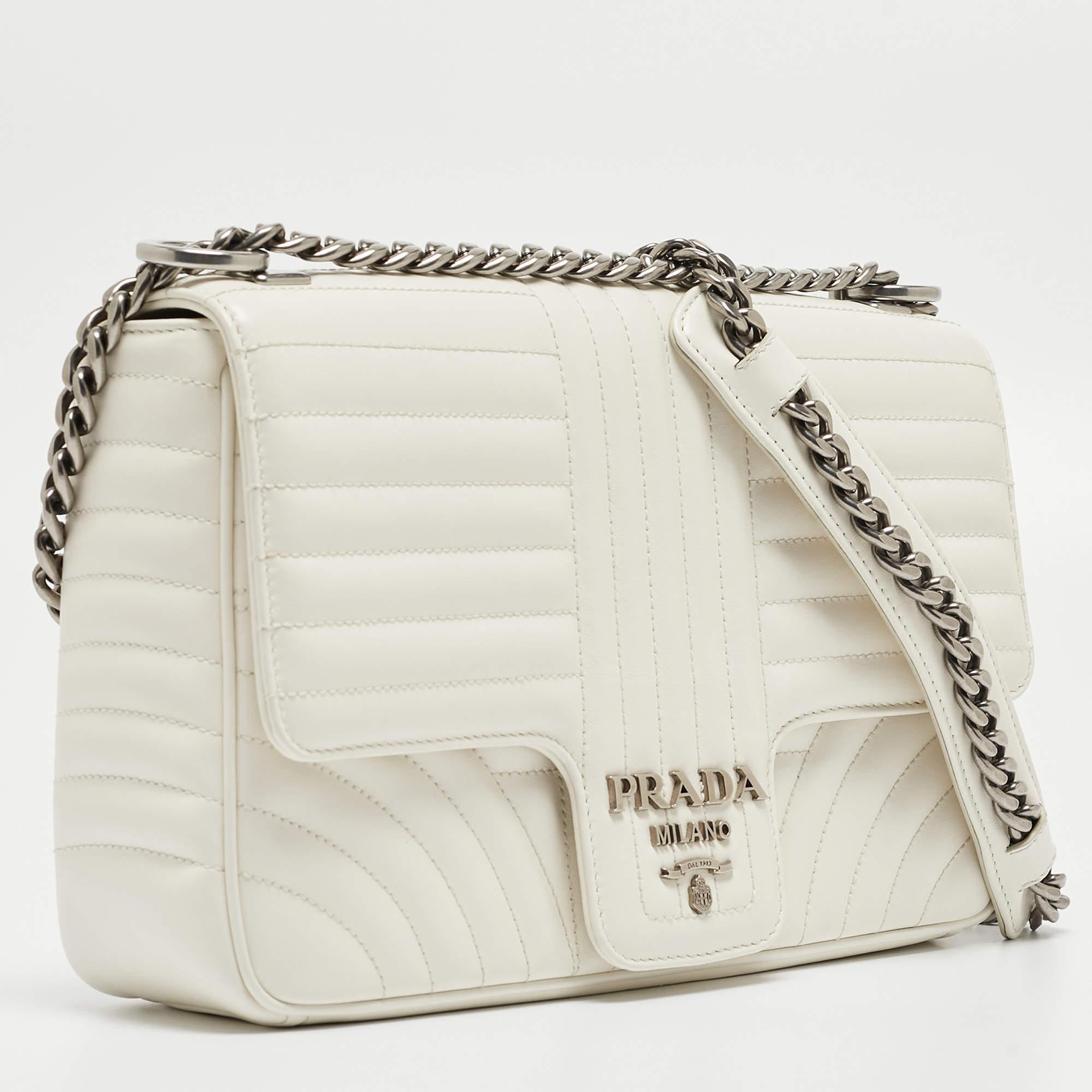 Prada brings you one such fabulous bag meticulously made from leather carrying a quilted pattern all over. This shoulder bag comes with a front flap detailed with the brand logo in gold-tone. It has a nylon-lined interior featuring a zip pocket. The