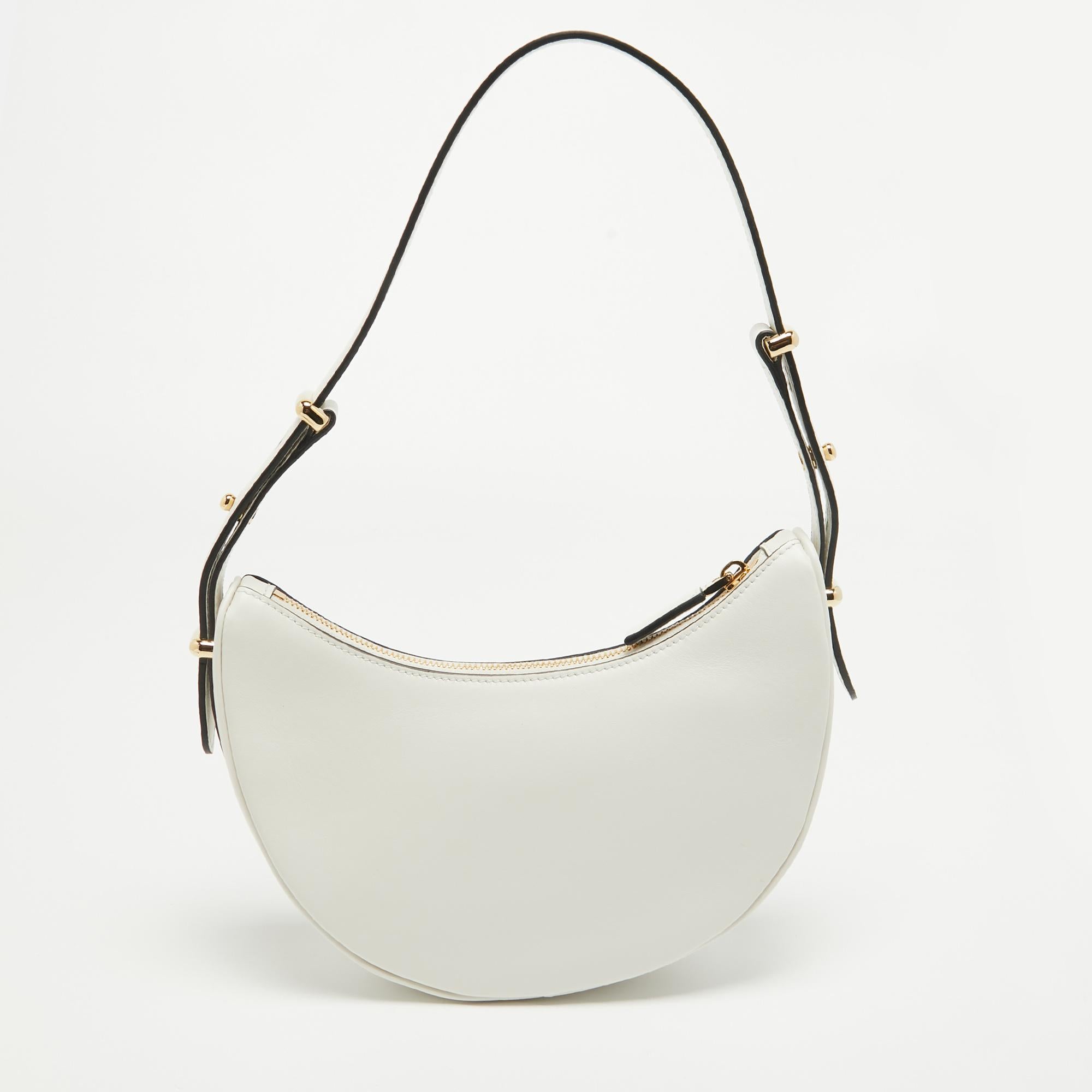 Crafted from pristine white leather, the Prada Arqué Bag exudes understated luxury. Its sleek silhouette is accentuated by delicate stitching and a subtle logo. With a spacious interior and adjustable shoulder strap, it seamlessly combines