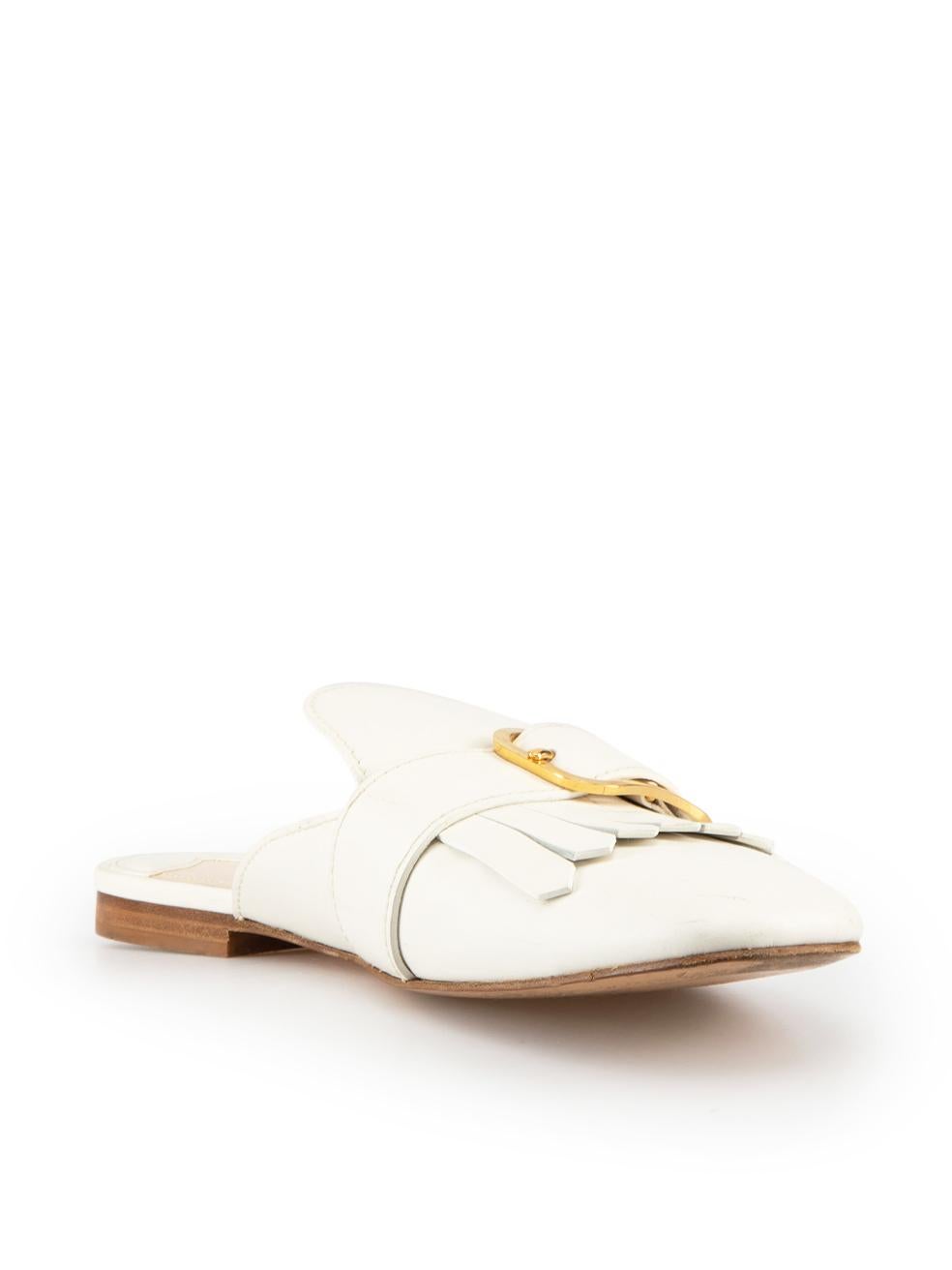 CONDITION is Good. Minor wear to mules is evident. Light indents and scuff marks to front of toes and minor creasing to leather on this used Prada designer resale item.

Details
Kiltie
White
Leather
Mules
Gold tone buckle detail
Square toe
Fringe