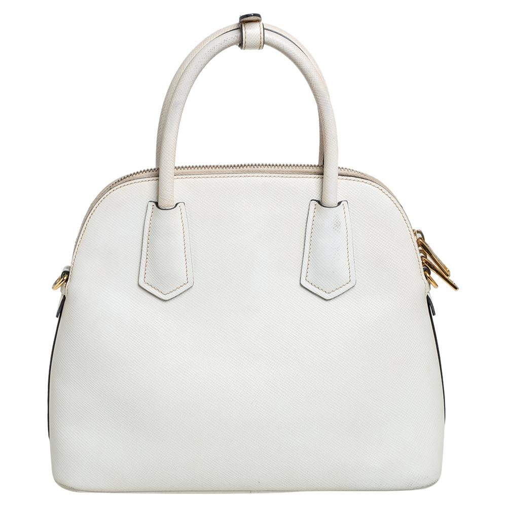High in appeal and style, this satchel is a Prada creation. It has been crafted from white leather and shaped to exude class and luxury. The bag is adorned with gold-tone hardware and comes with two handles and a spacious interior for your ease.