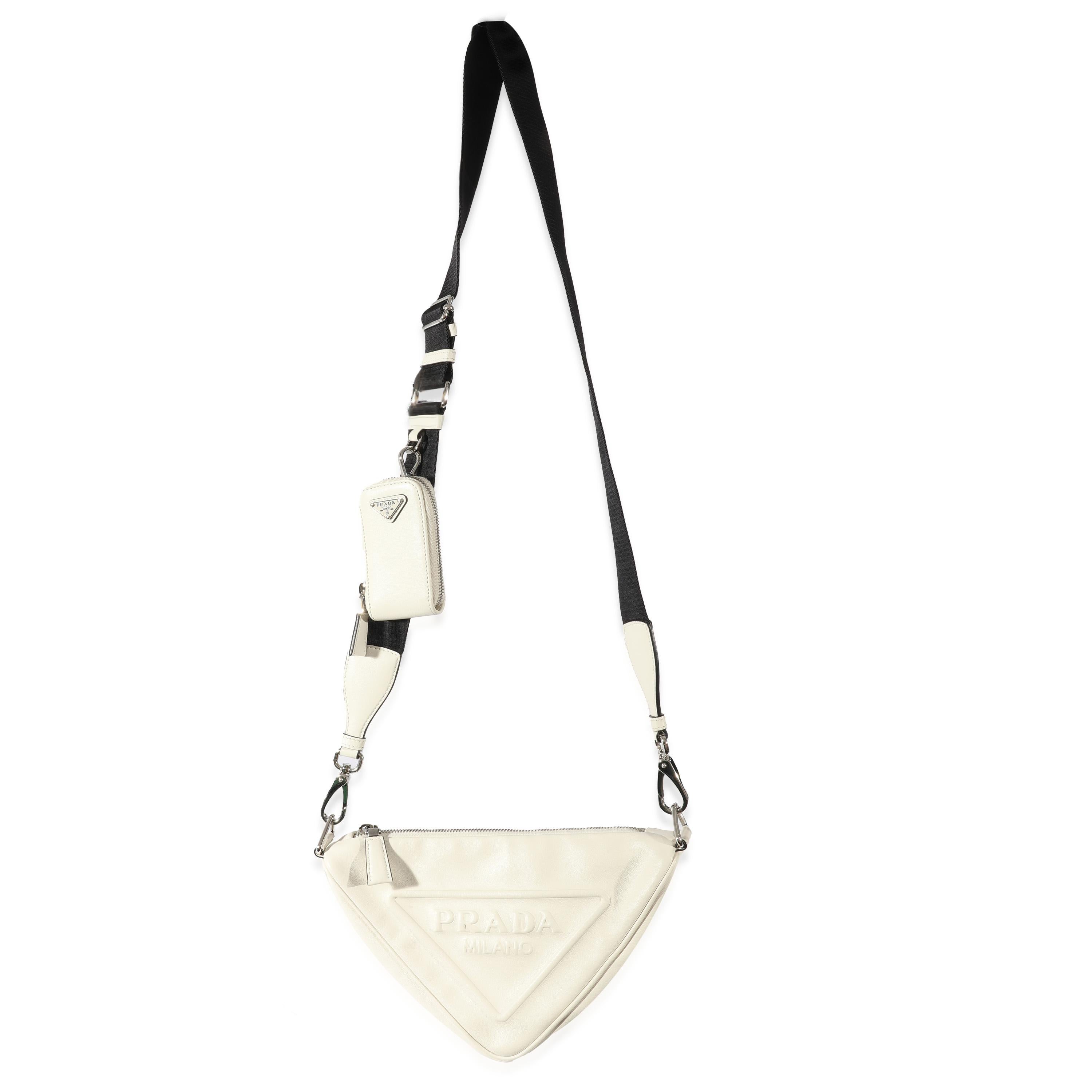 Listing Title: Prada White Leather Triangle Crossbody Bag
 SKU: 128615
 MSRP: 2500.00
 Condition: Pre-owned 
 Handbag Condition: Very Good
 Condition Comments: Very Good Condition. Discoloration and marks to leather. Hairline scratching to hardware.