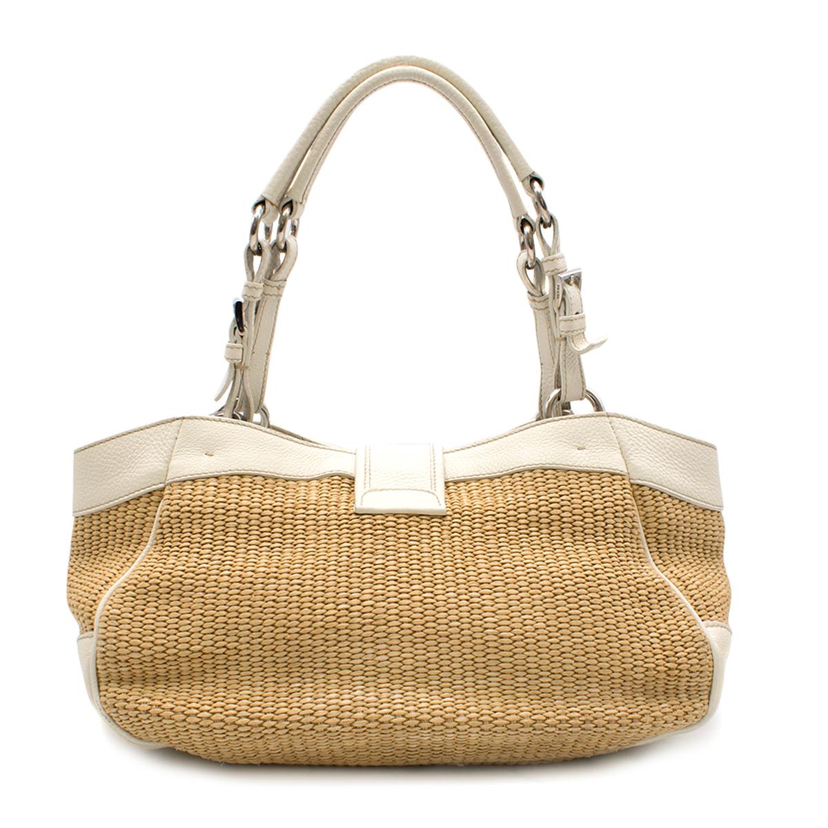 Prada White Leather Wicker Hand Bag

- White leather hand bag 
- Wicker main body 
- White leather hands
- Two front Push button pockets 
- Front of the bag embellished with faux buckles
- One main compartment 
- Flip and magnetic button fastening
