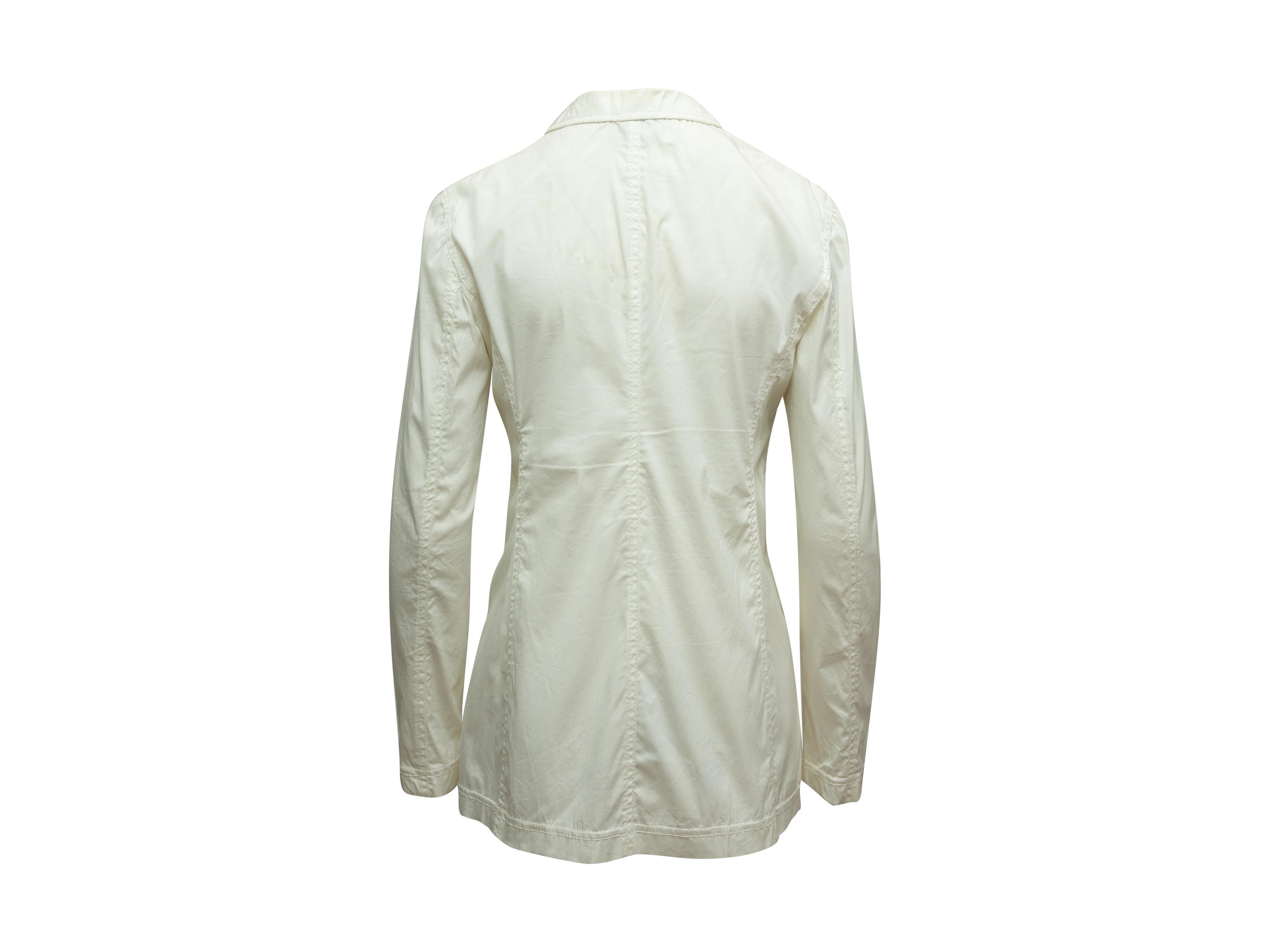Product details: White long sleeve lightweight blazer by Prada. Notched collar. Three patch pockets. Button closures at center front. Designer size 44. 28