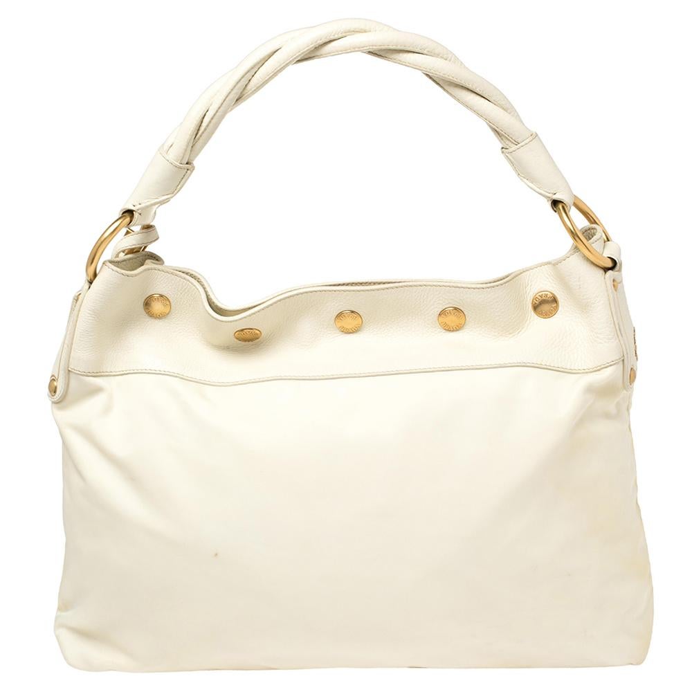 This hobo by Prada is crafted from nylon and leather in white. The bag has a fine finish and a classic appeal. It comes with a single braided handle, gold-tone studs, brand tag, and a nylon-lined interior with a zip pocket inside.

