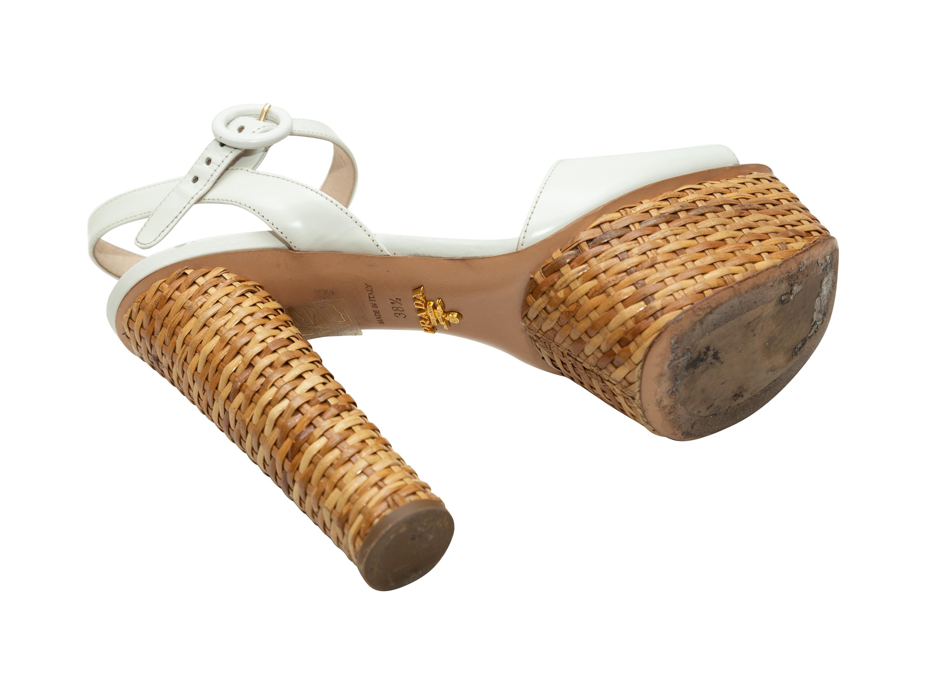 Product details: White patent leather platform sandals by Prada. Straw trim at heels and platforms. Tonal buckle closures at ankle straps. Designer size 38.5. 5.5