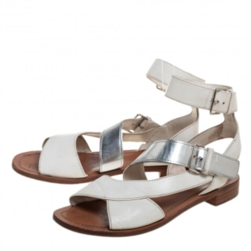 Trendy, comfortable, and stylish, these Prada sandals are closet essentials! They are crafted from leather in a strappy design and exhibit white and silver shades. Style them with cropped pants and tops for a chic appeal.