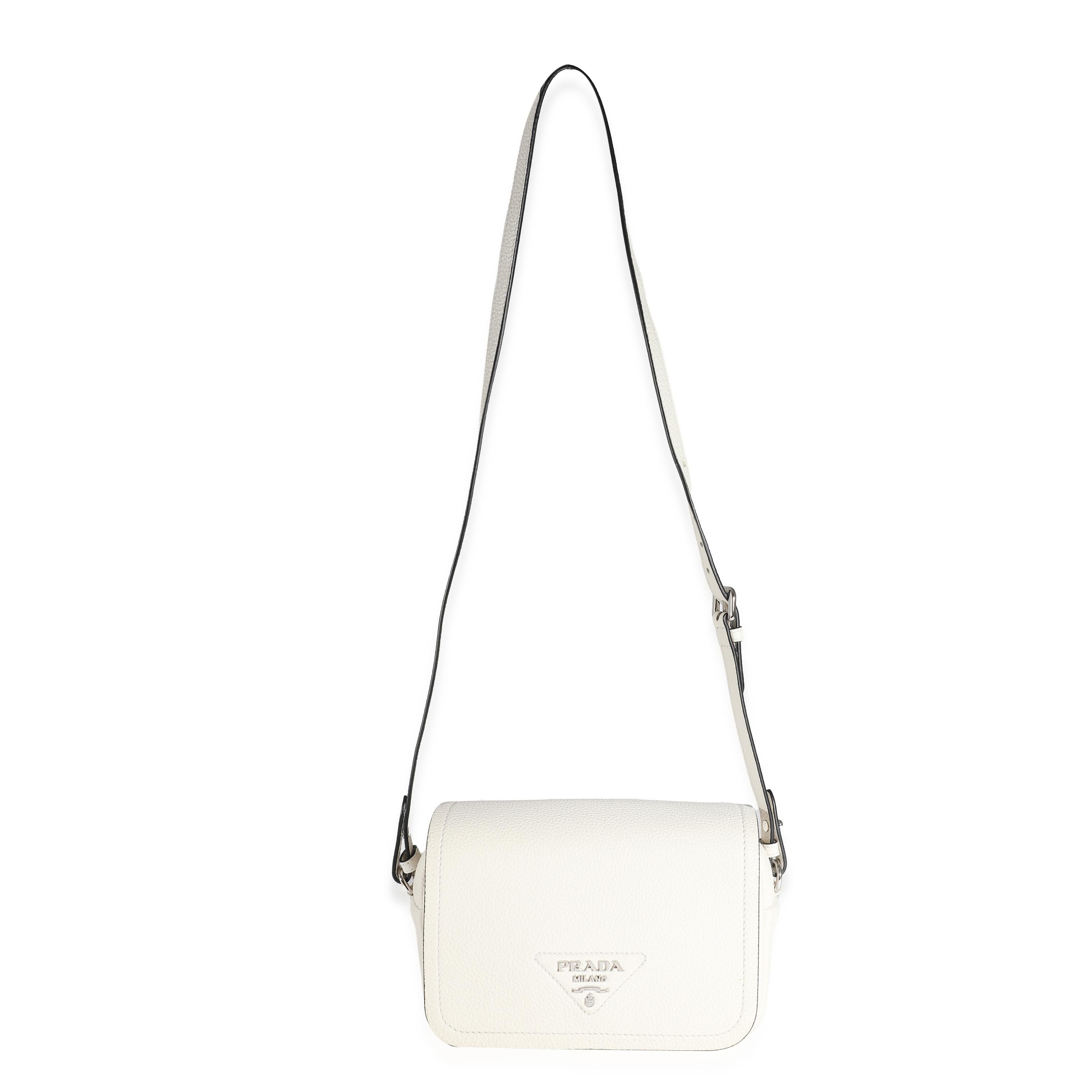Listing Title: Prada White Vitello Daino Logo Crossbody Flap Bag
SKU: 132391
Condition: Pre-owned 
Handbag Condition: Excellent
Condition Comments: Item is in excellent condition and displays light signs of wear. Light corner scuffing. Interior