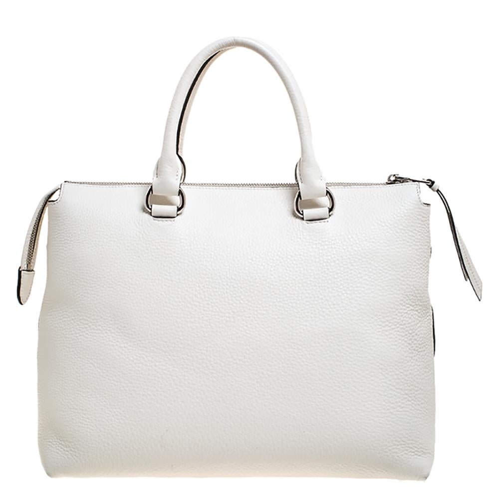 Prada bags are coveted around the world for their classic design and exquisite quality. This convertible bag is no different. Crafted from Vitello Phenix leather, this bag comes in a lovely shade of white. it is styled with dual handles, a
