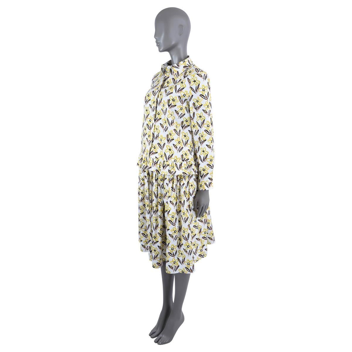 100% authentic Prada floral print skirt outfit in white, lime, yellow, brown and black cotton (94%) and elastane (6%) with a straight collar. Features ruffled hem. Closes with buttons on the front and button cuffs. Comes whit a matching pleated