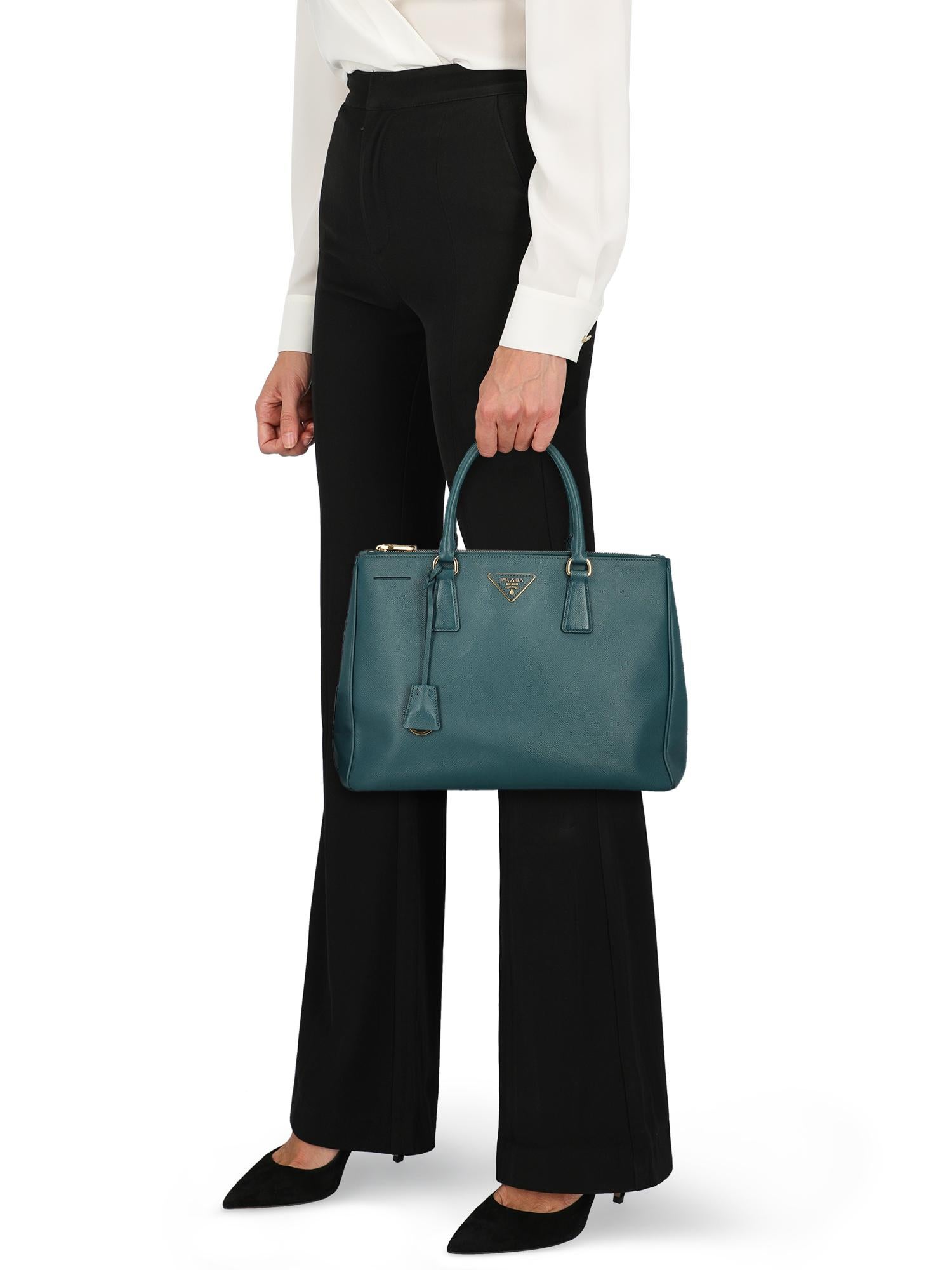 Product Description: Introduced in 2007, the Galleria Bag by Prada is still a standout piece today given its minimal design and unmistakable silhouette. Equipped with three separate sections ‒ two zipped compartments plus one spacious central