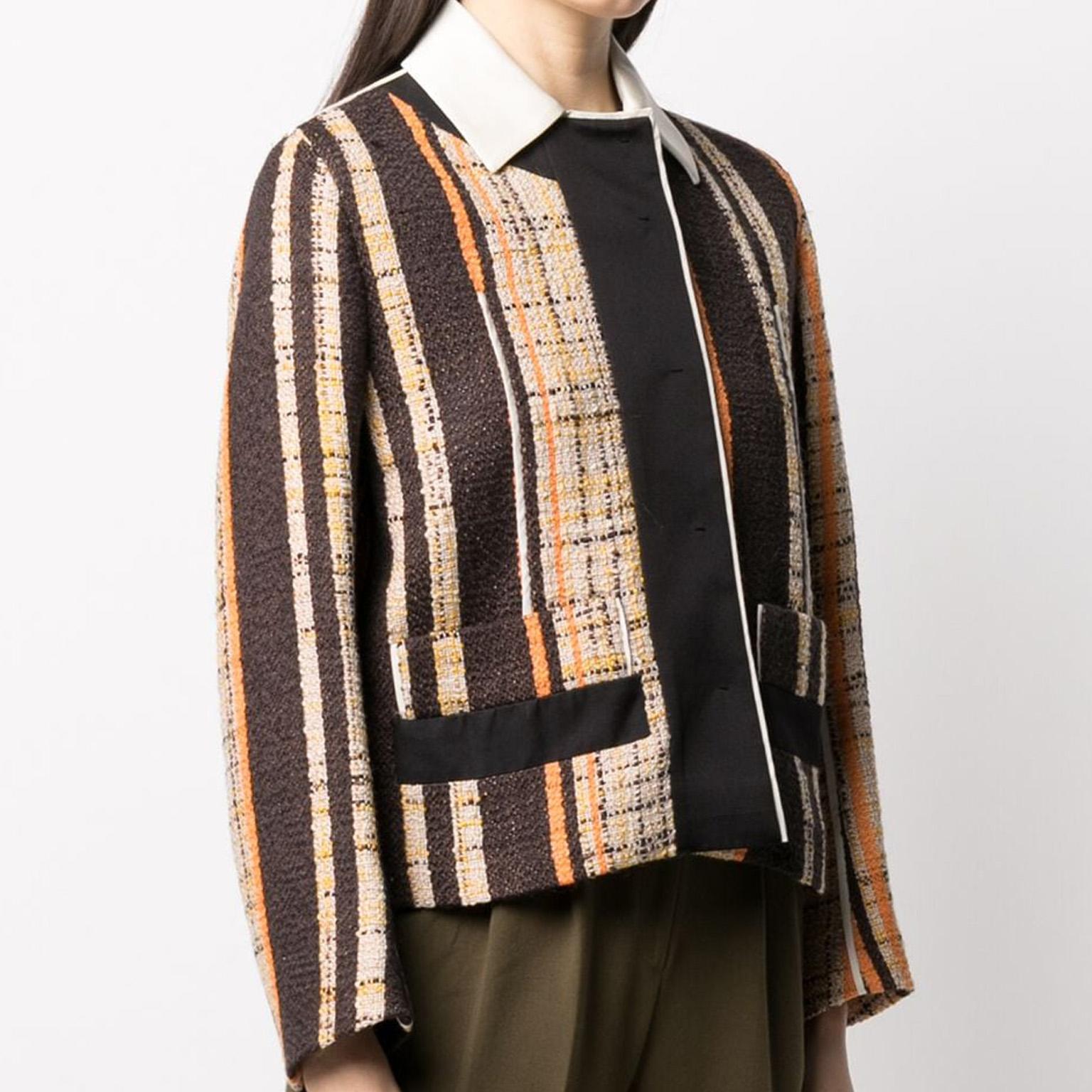Beautifully structured blazer by Prada in earthy hues of orange, brown and cream. Featuring a contrasting white collar, concealed front fastening, and two front patch pockets. Crafted from wool, with an intriguing and unique interwoven design makes