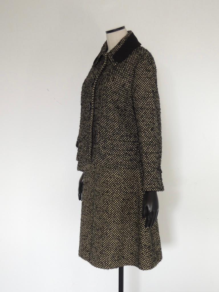 Vintage-inspired Prada skirt and jacket, styled like a 1960s skirt suit, with decorative front pockets. The suit is composed of a textured virgin wool (66%), mohair (18%) and nylon (16%).

Tagged a size 46 (jacket) and 44 (skirt).

This is in
