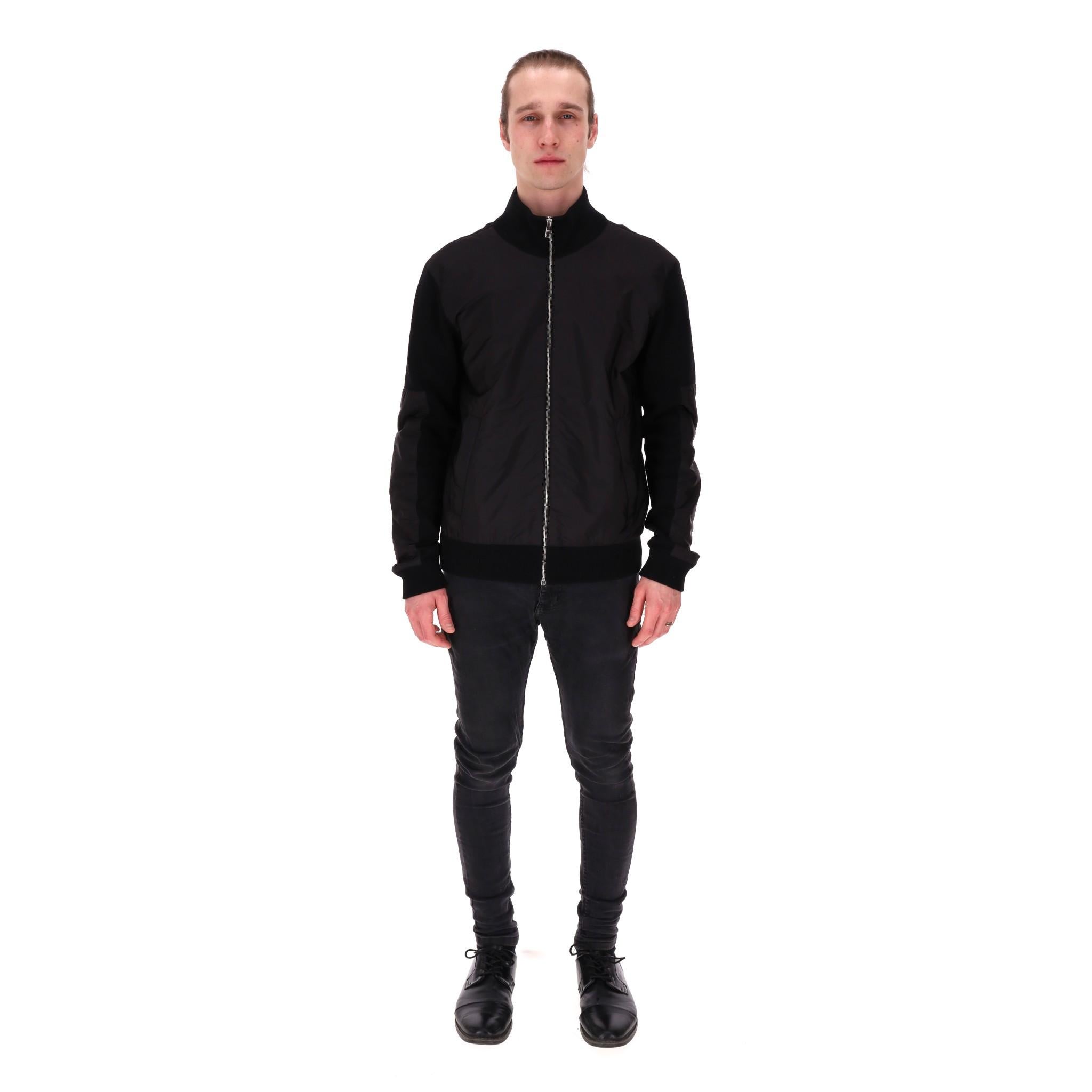 Prada Wool & Nylon Bomber Jacket

Black bomber jacket designed with wool knitted rear and sleeves with tonal nylon front and sleeves panels.

Featuring centre zip closure, side pockets and ribbed stand collar, cuffs and hem.

Rrp Approx.