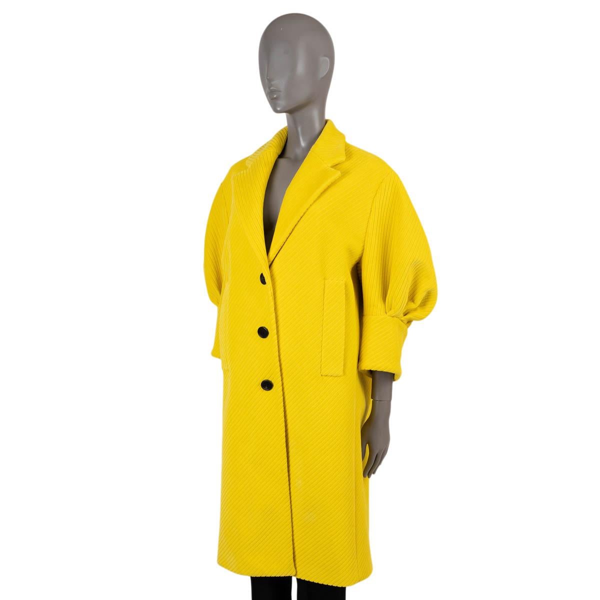 100% authentic Prada puff-sleeve coat in canary yellow corduroy velvet (cotton with 10% polyester). Features wide peak lapels, two welt pockets and central rear vent. Closes with buttons on the front and is lined in viscose (100%). Has been carried