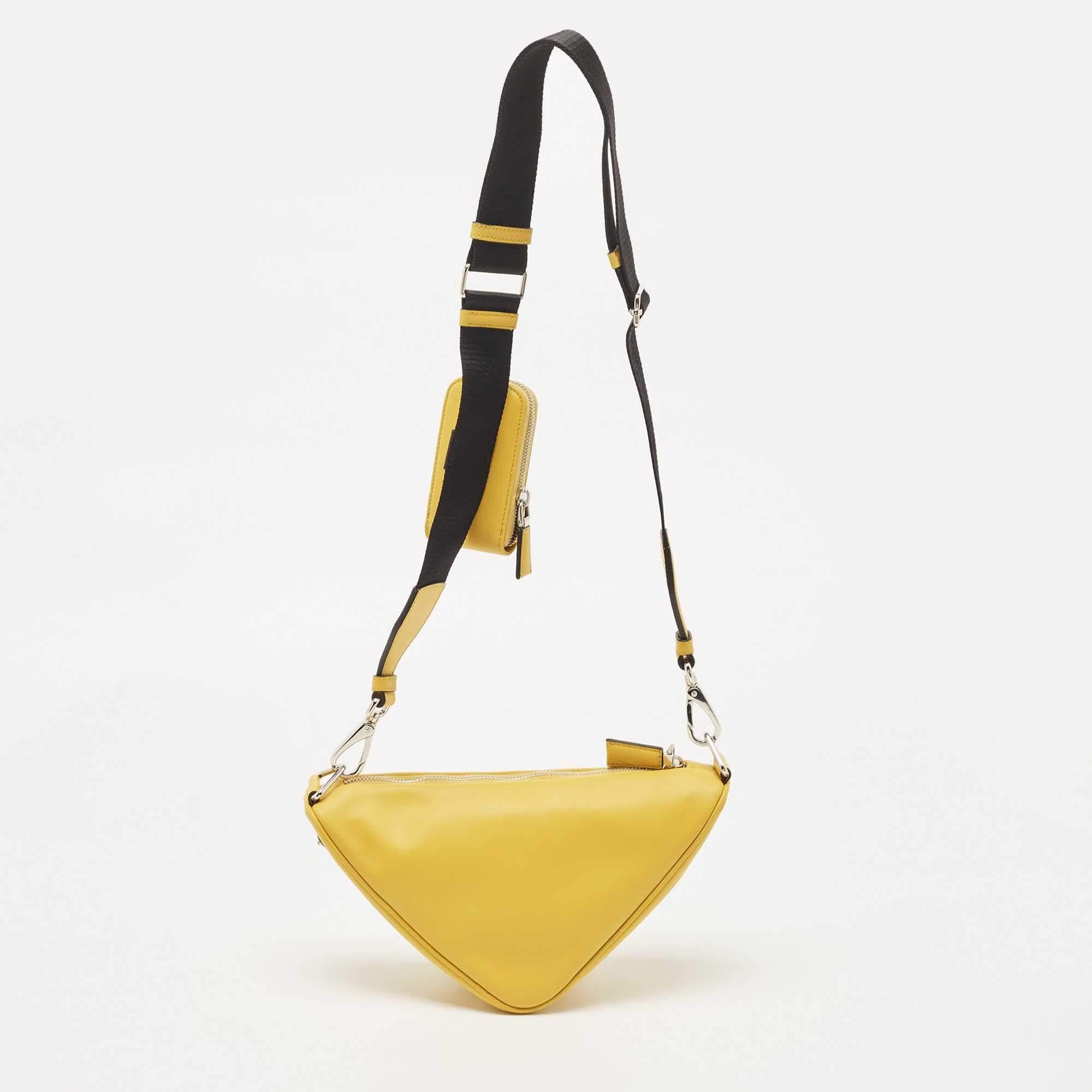 Designed to last, this awesome bag from Prada can uplift the look of your outfit. Crafted from leather in a distinctive triangular shape, this duffle bag exudes style, simplicity, and elegance in equal measures.

Includes: Original Dustbag,