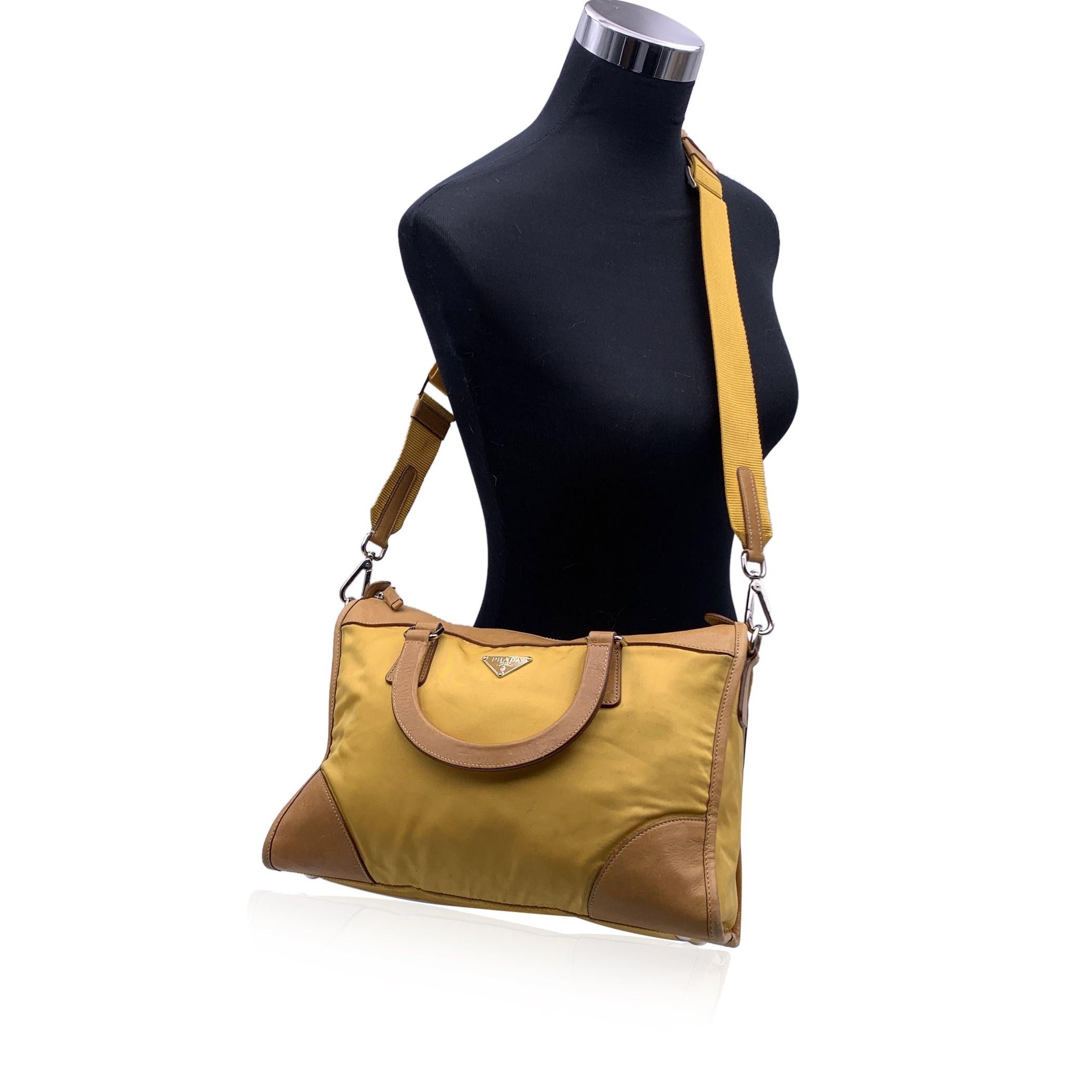 Stunning PRADA top handles bag/handbag , designed in yellow nylon with leather trim. Triangle logo on the front. It features double top handles and a removable and adjustable shoulder strap . Upper zipper closure. Prada signature lining. 1 side zip