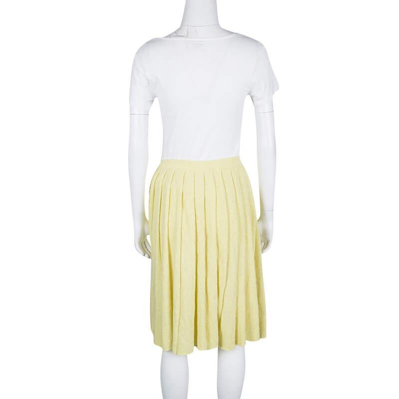 Prada's yellow skirt ensures a flattering silhouette with its comfortable length and beautifully pleated design. It is a perfect piece for casual day outs, so pair it with a fitted top and sneakers to look stylish.

