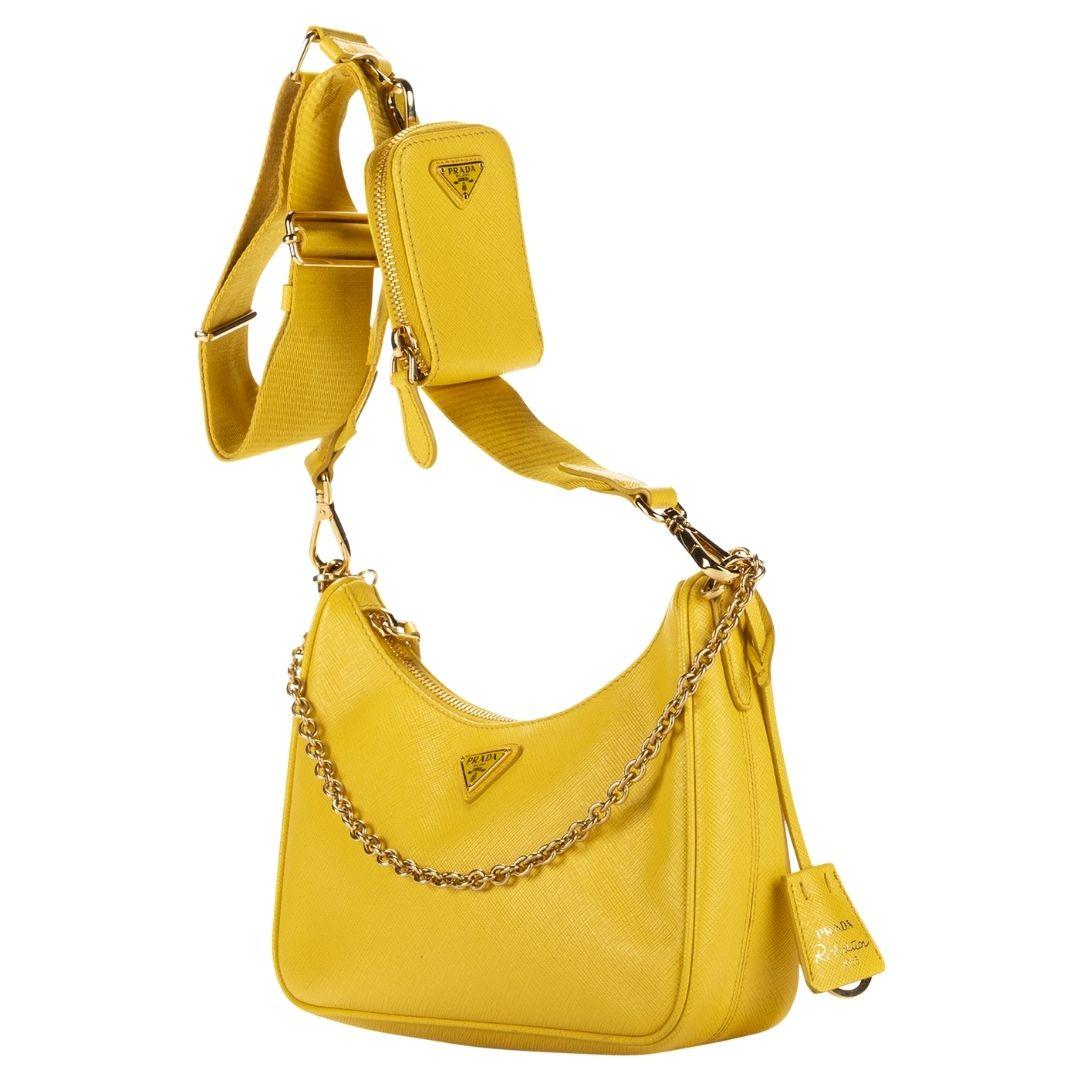 Prada's vibrant yellow saffiano leather crossbody bag, a re-edition from 2005, features gold-tone hardware and a zipper closure. The interior unveils a logo jacquard lining.

SPECIFICS
Length: 8.7