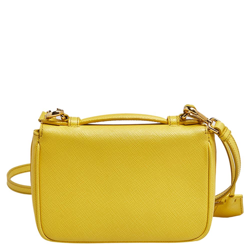 The classic, minimalistic Prada bag is styled in yellow Saffiano leather. Furnished with a fabric compartment and a gold-tone lock, this bag is functional while remaining elegant and chic—classic Prada traits.

Includes: Original Dustbag, Strap
