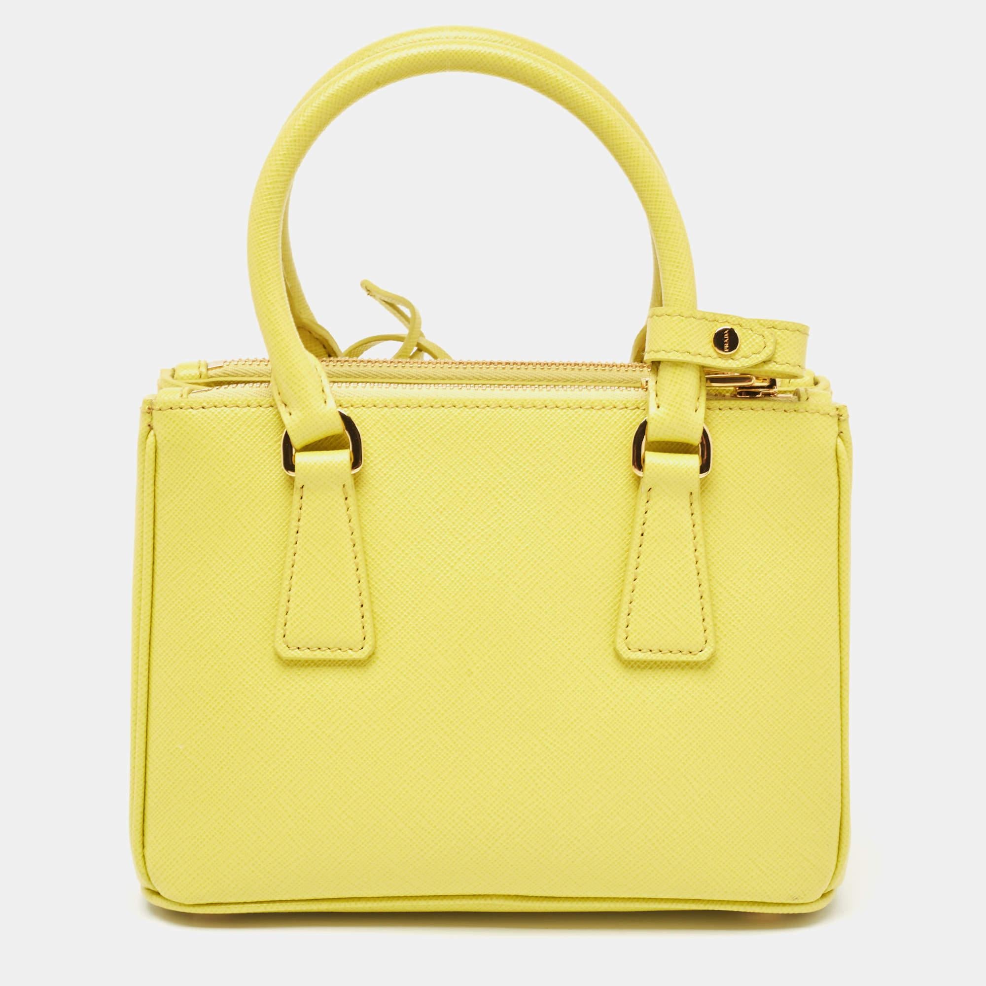 Loved for its classic appeal and functional design, Galleria is one of the most iconic and popular bags from the house of Prada. This beauty in yellow is crafted from Saffiano leather and is equipped with two top handles, the brand logo at the