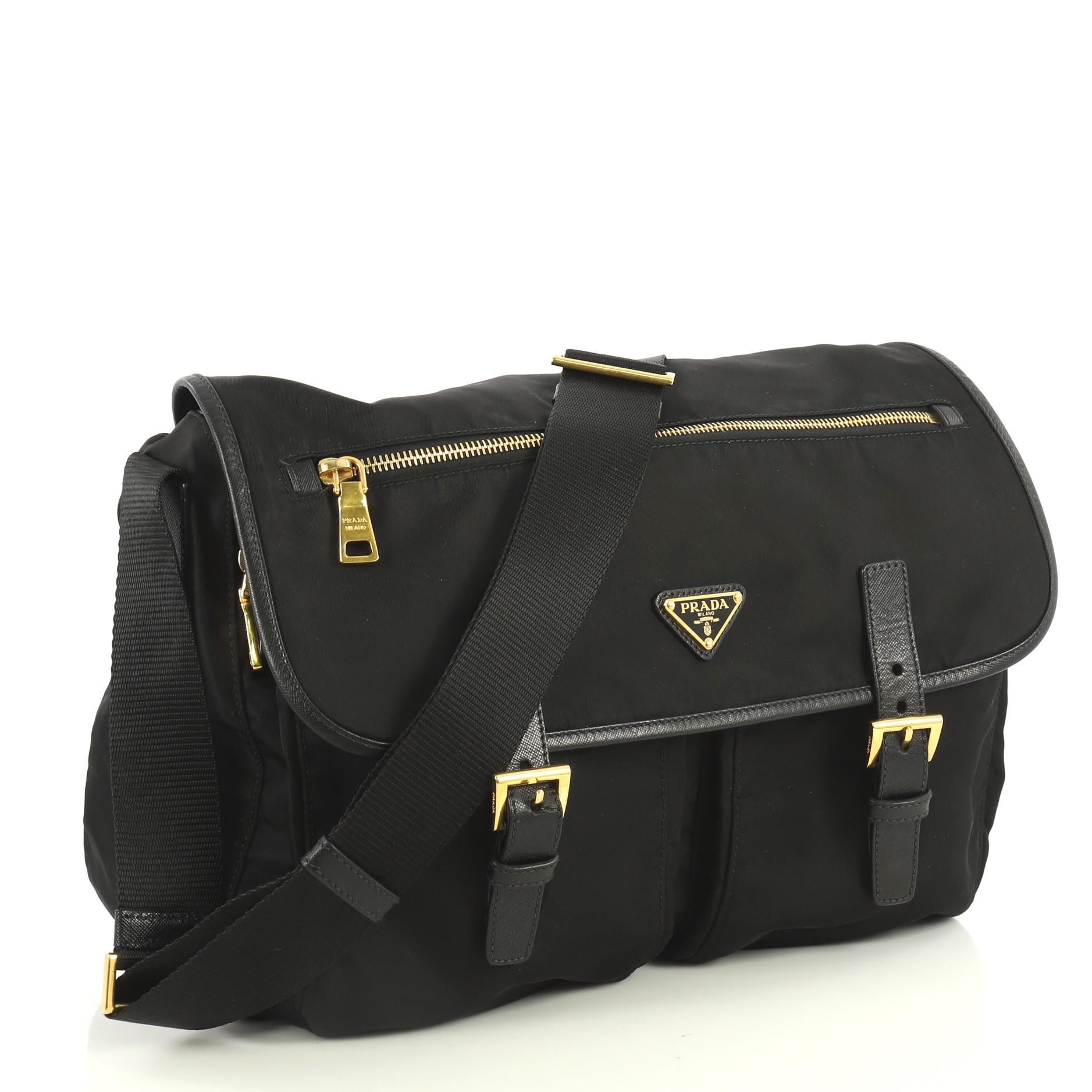 This Prada Zip Buckle Messenger Bag Tessuto Large, crafted from black tessuto, features an adjustable shoulder strap, exterior front zip pocket on flap, two zip pockets under flap, and gold-tone hardware. Its flap and zip closures open to a black